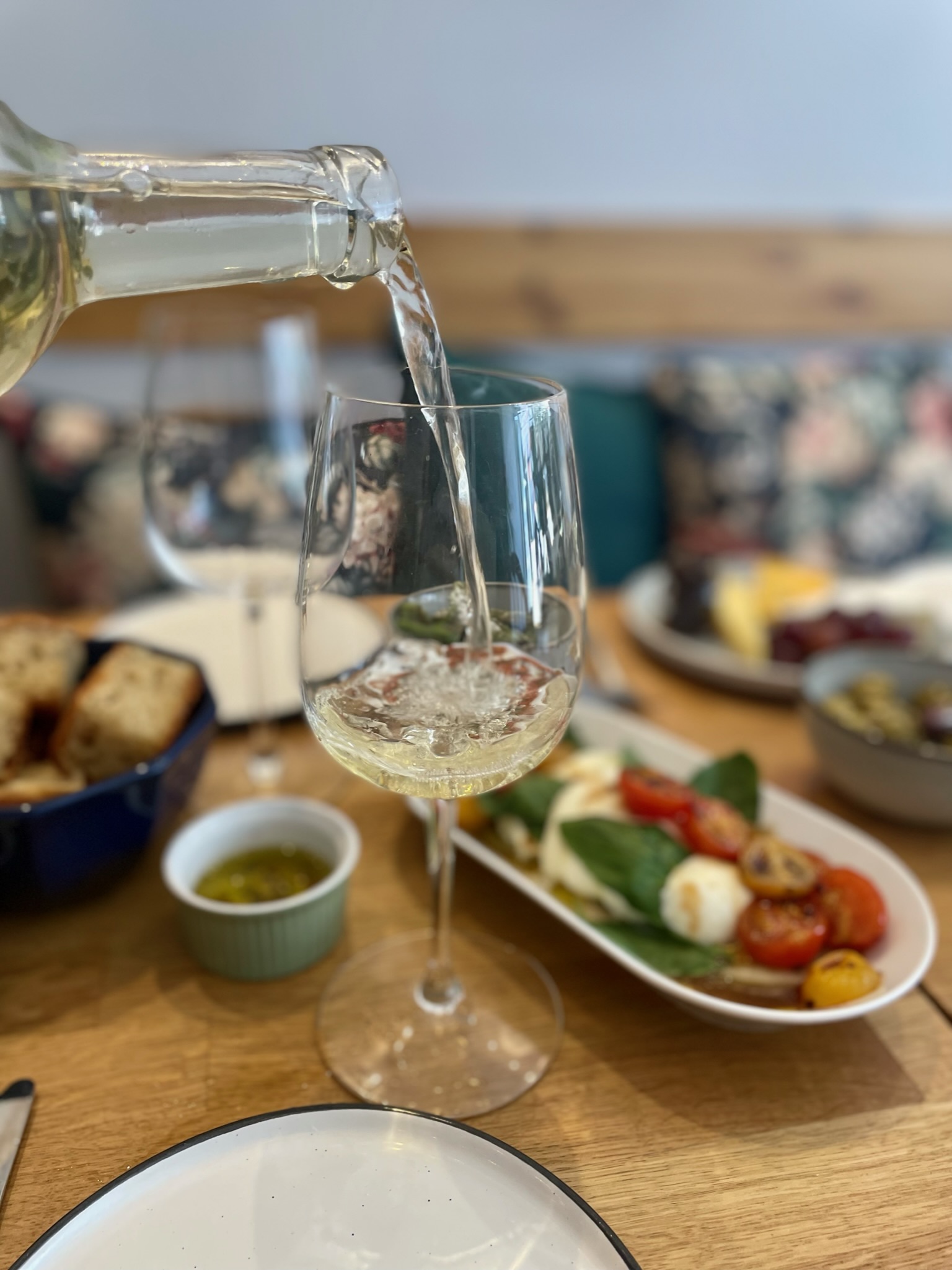Elegant table setting with wine for a corporate networking event at The Luxury Picnic Cafe.