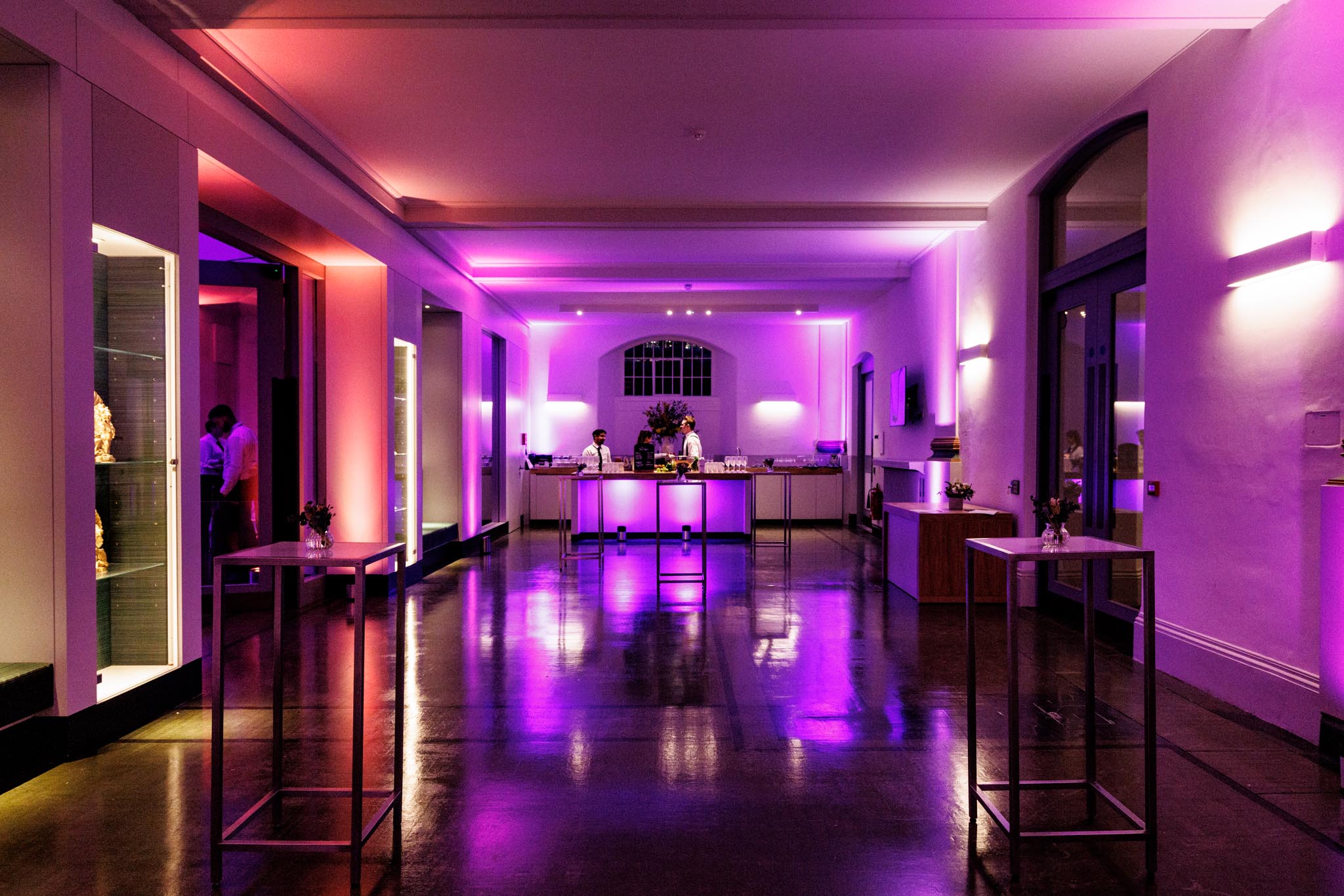 Stylish event space with purple lighting, ideal for receptions and cocktail events.