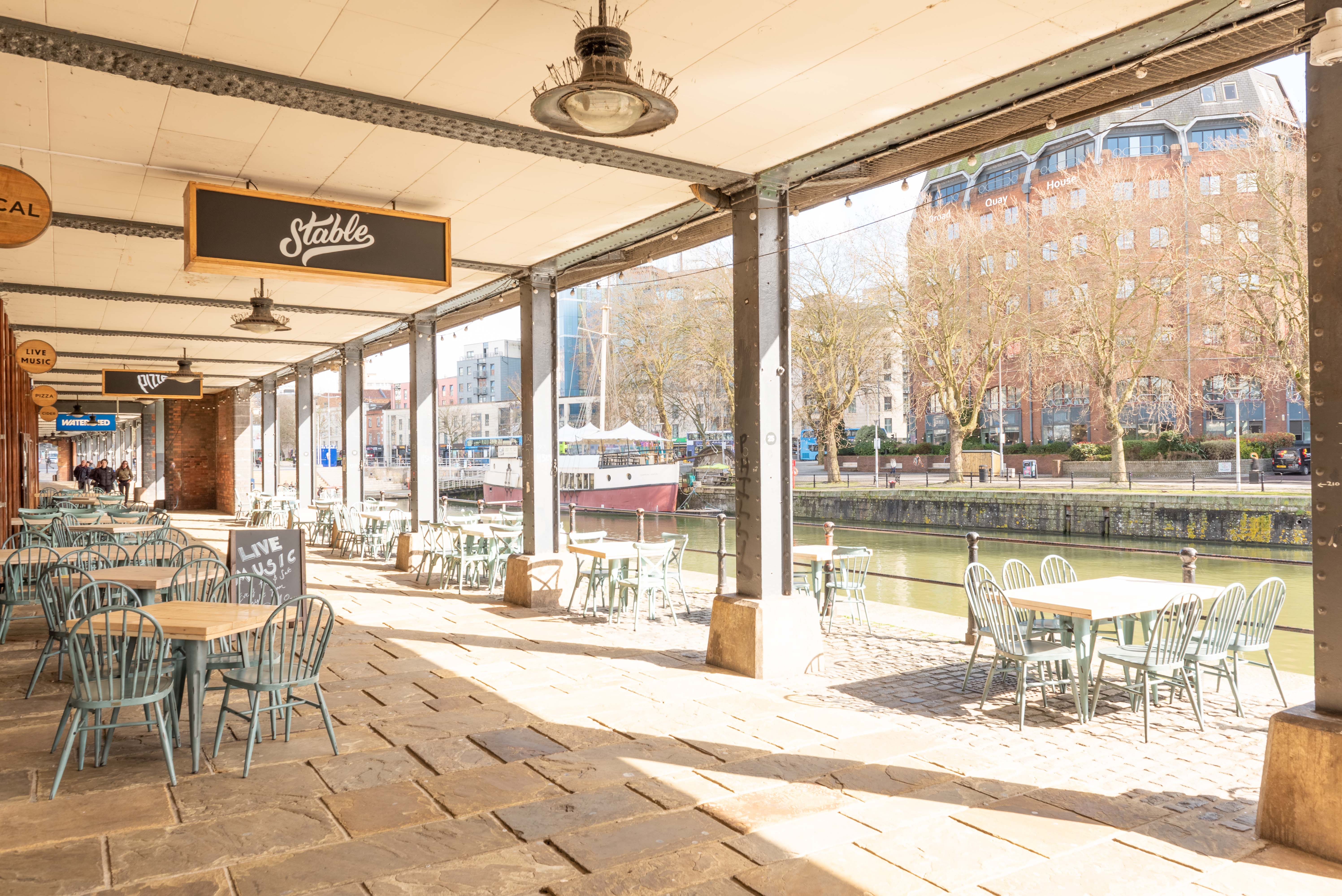 Charming waterfront venue with outdoor seating for casual meetings and events.