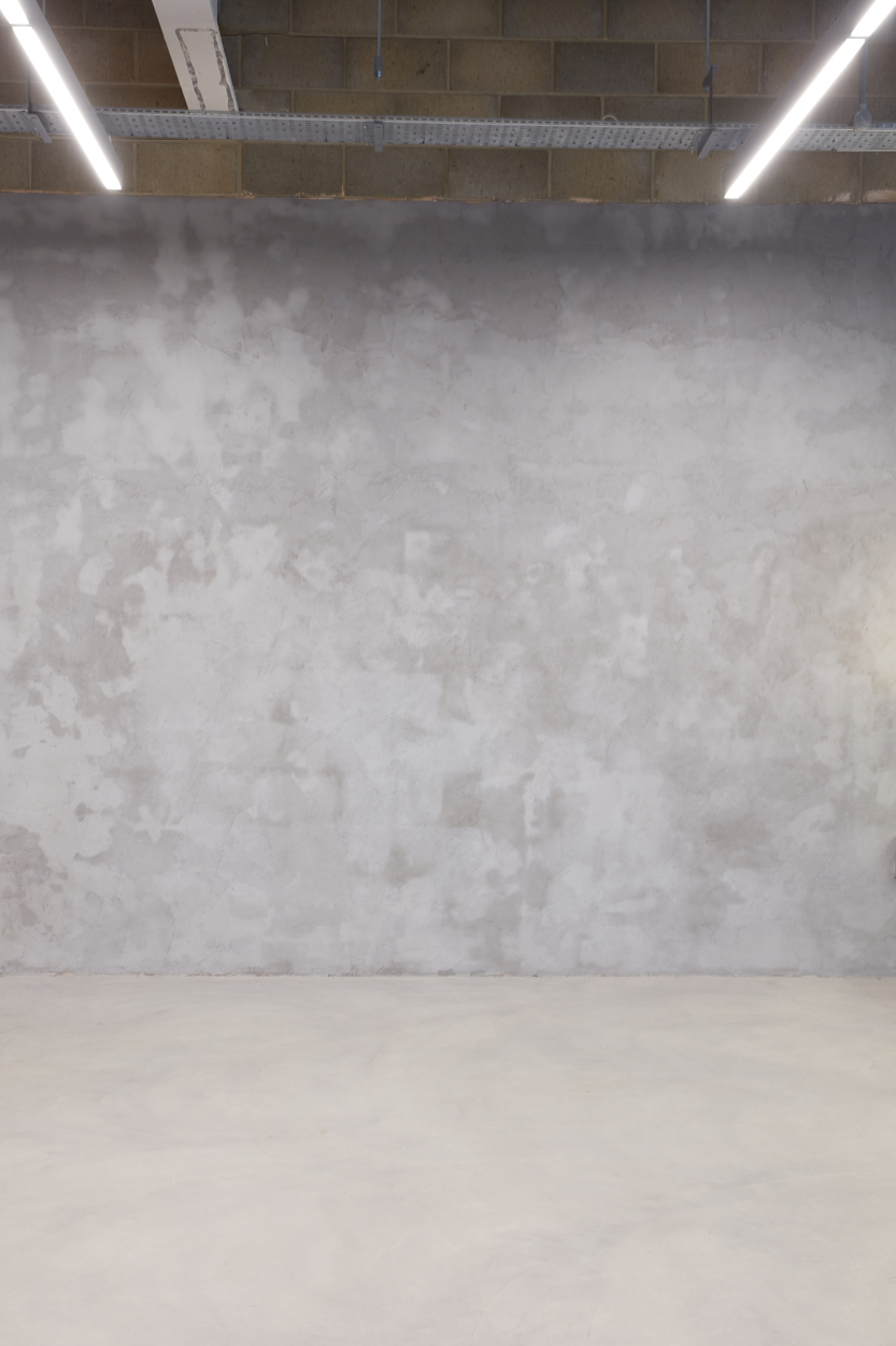 Neutral textured gray wall at The Vow Studio, ideal for events and presentations.