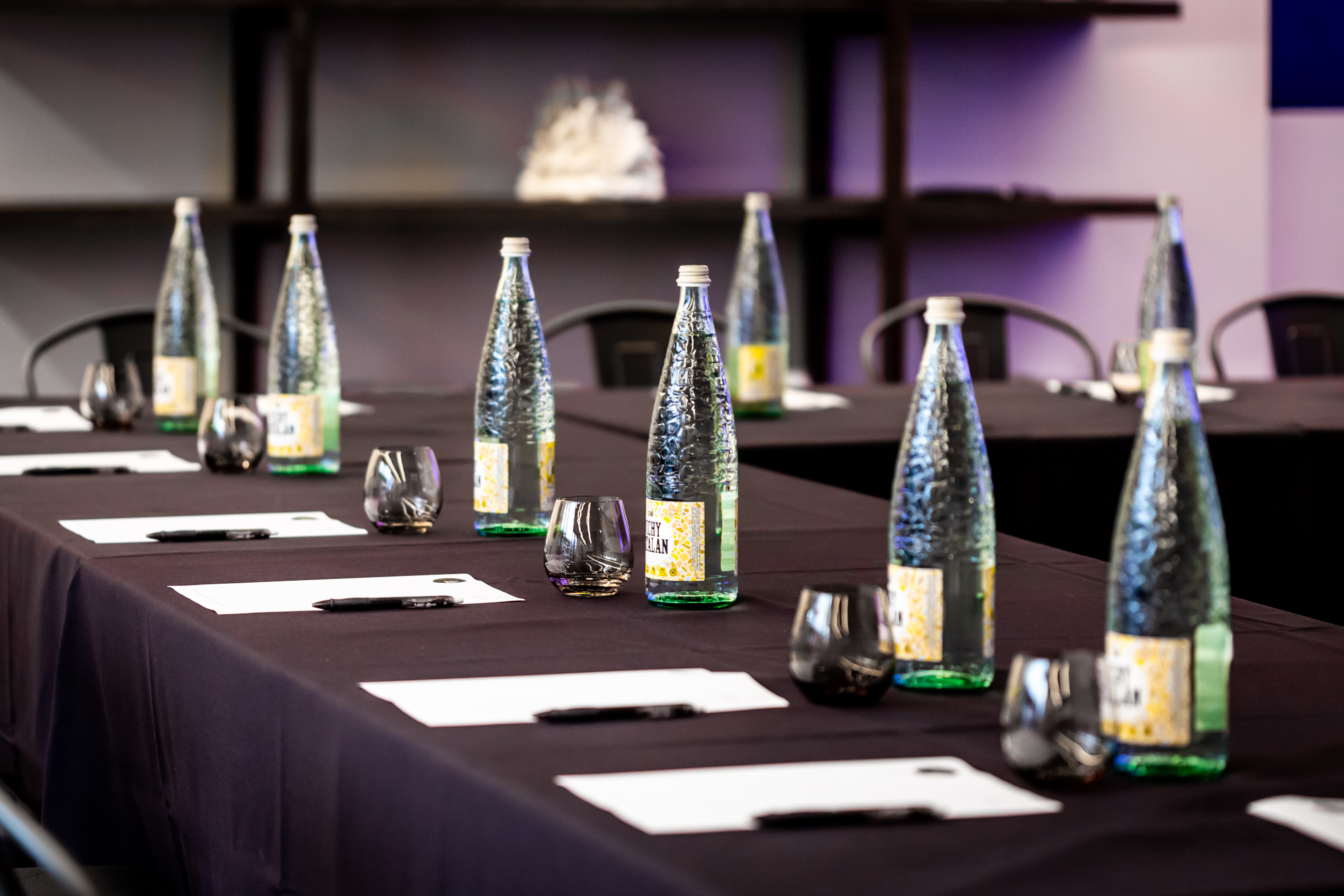 V8 & V12 Rooms meeting setup with black linens, elegant glassware for corporate events.