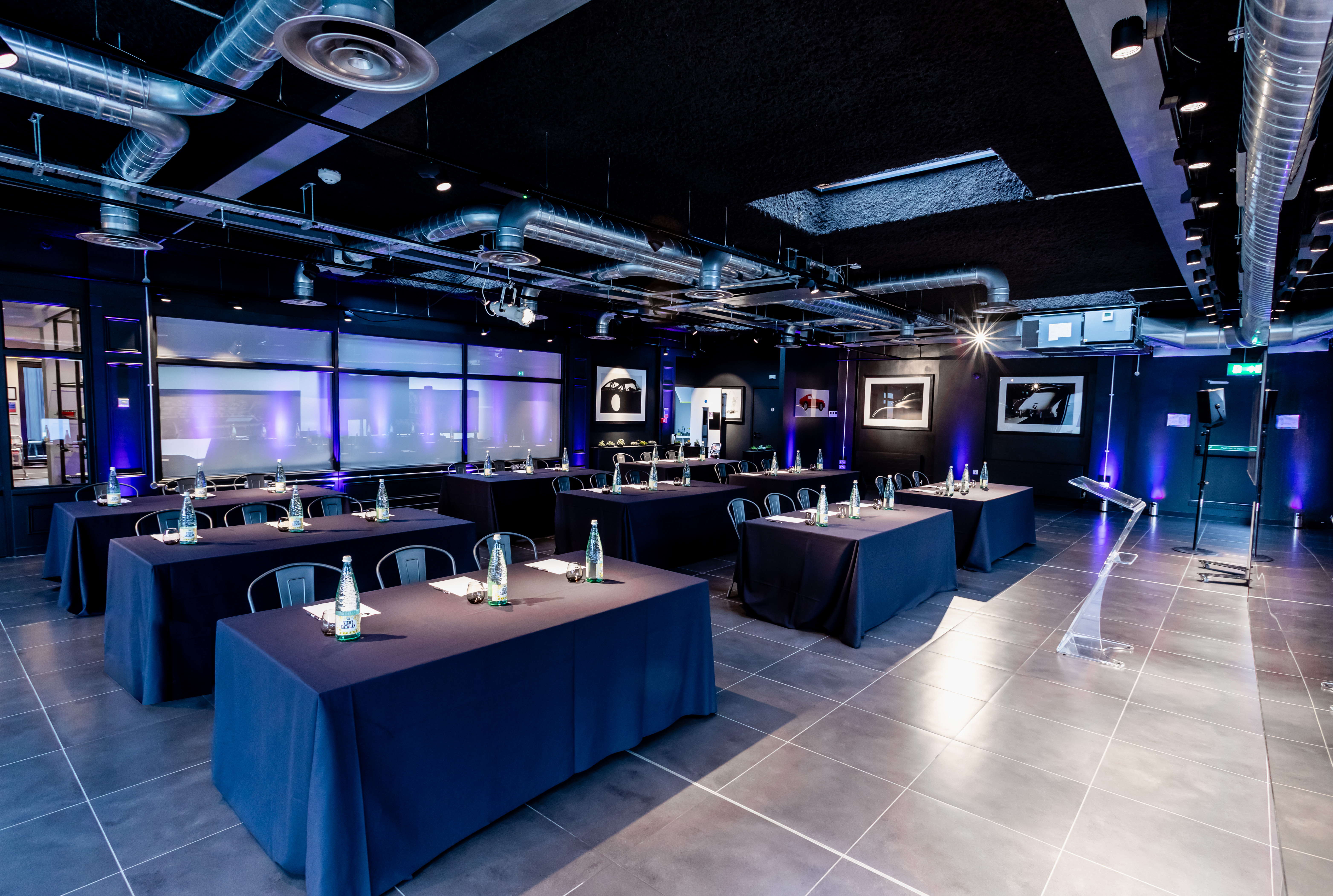 Modern event space with classroom setup, ideal for meetings and presentations.