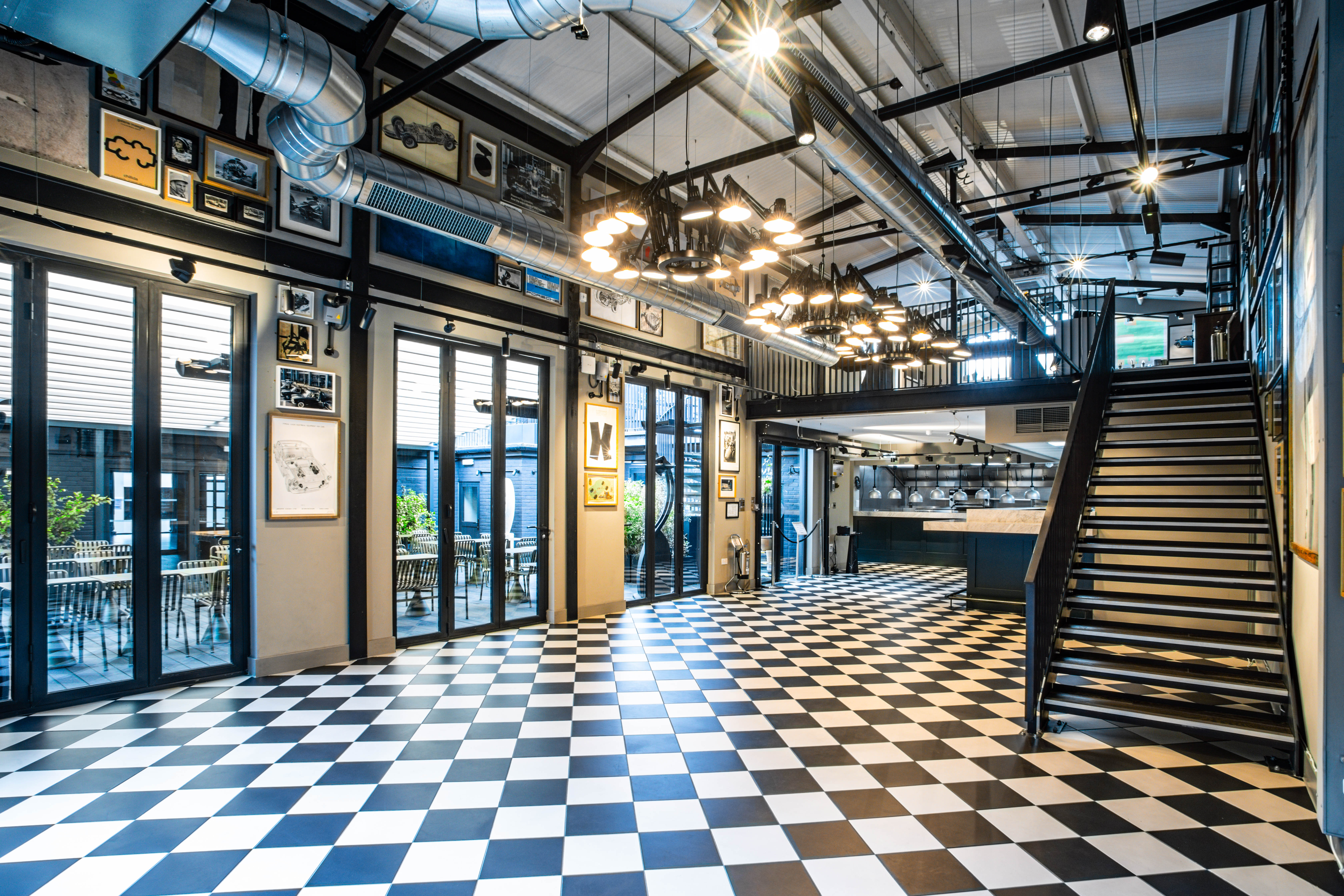 Stylish event space with checkered floor, ideal for networking and workshops.