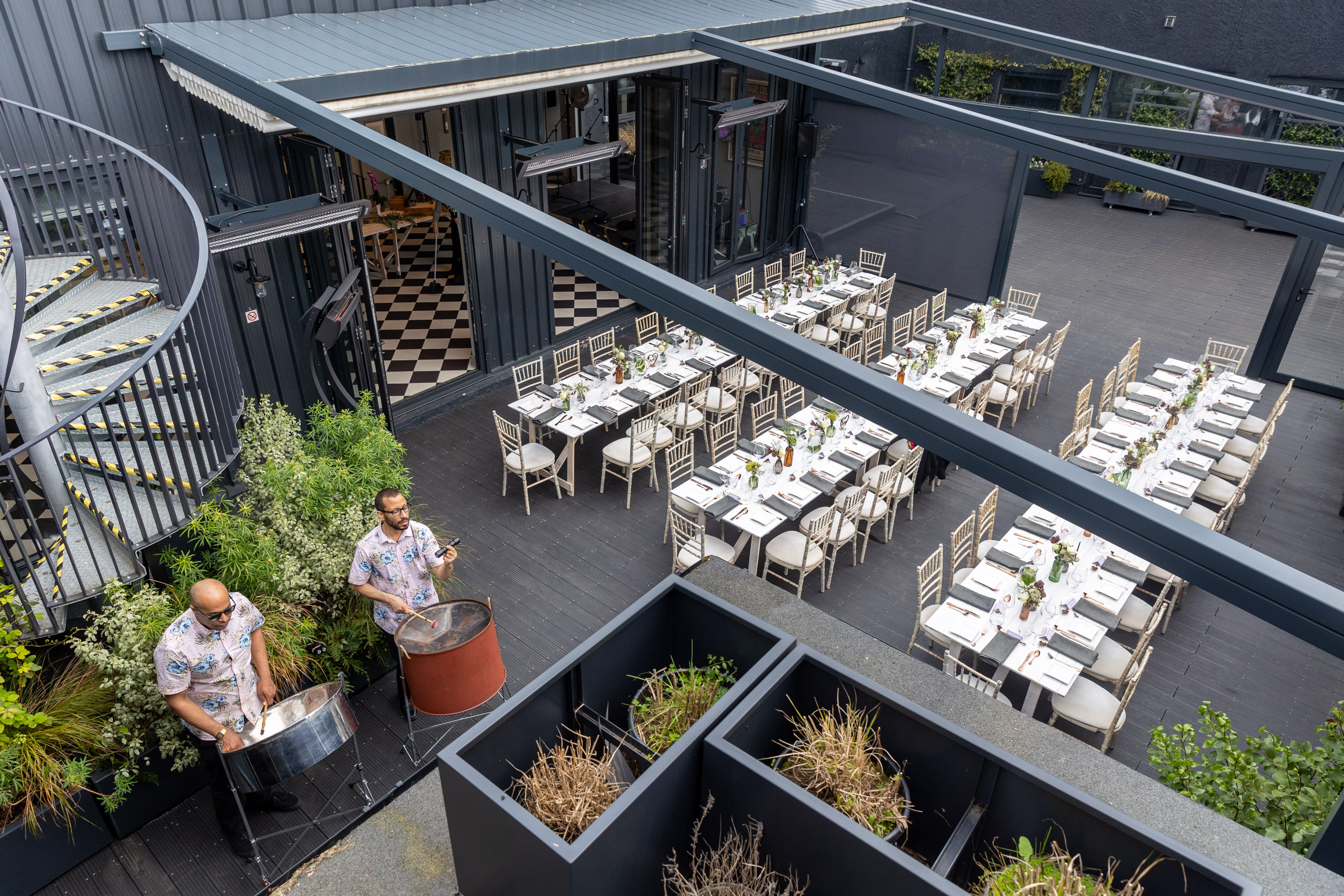 Stylish outdoor event space with spiral staircase, perfect for gatherings and celebrations.