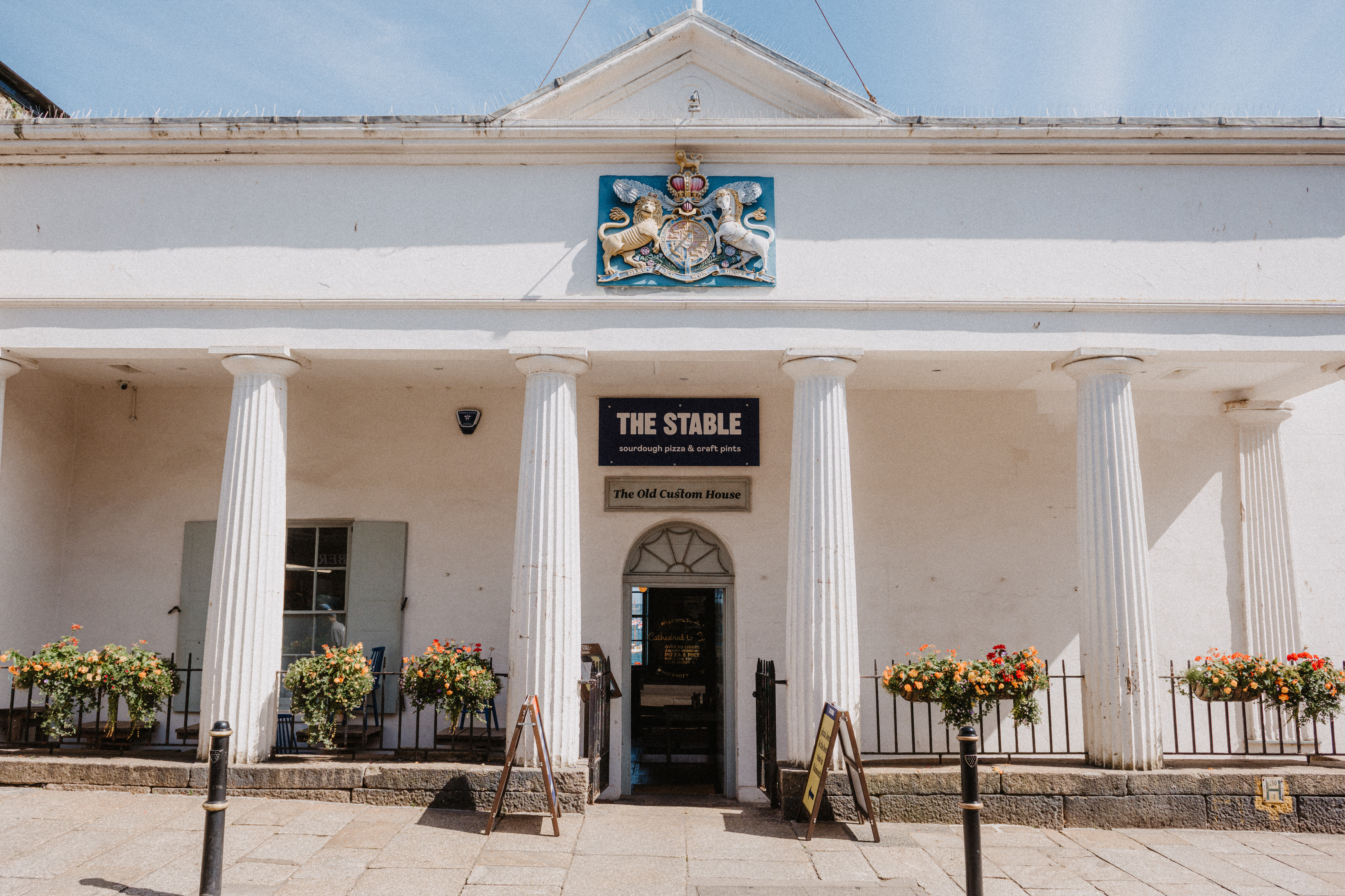 Charming Falmouth Stable venue with grand columns, perfect for events and gatherings.