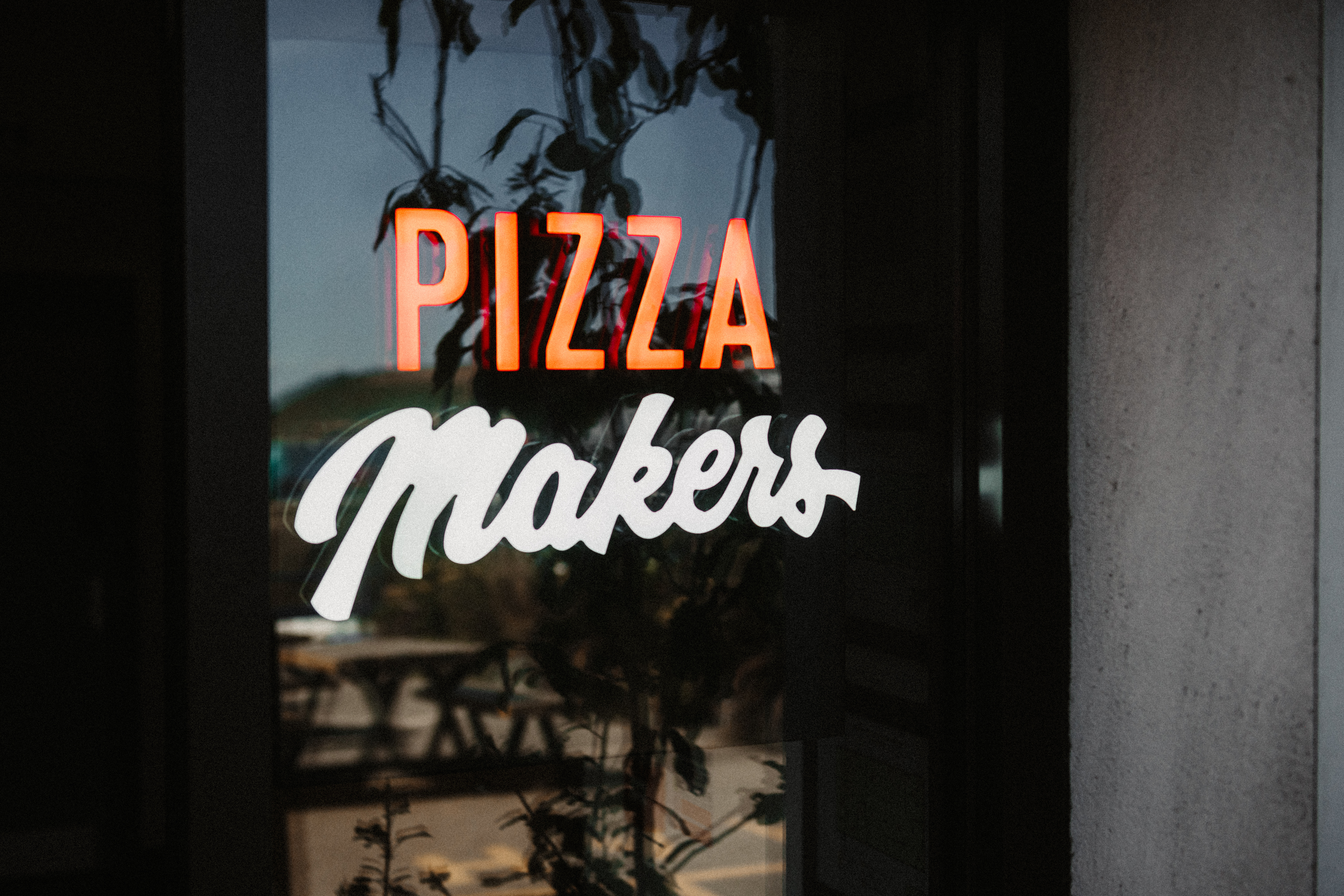"Vibrant Pizza Makers sign at The Falmouth Stable for casual team-building events."