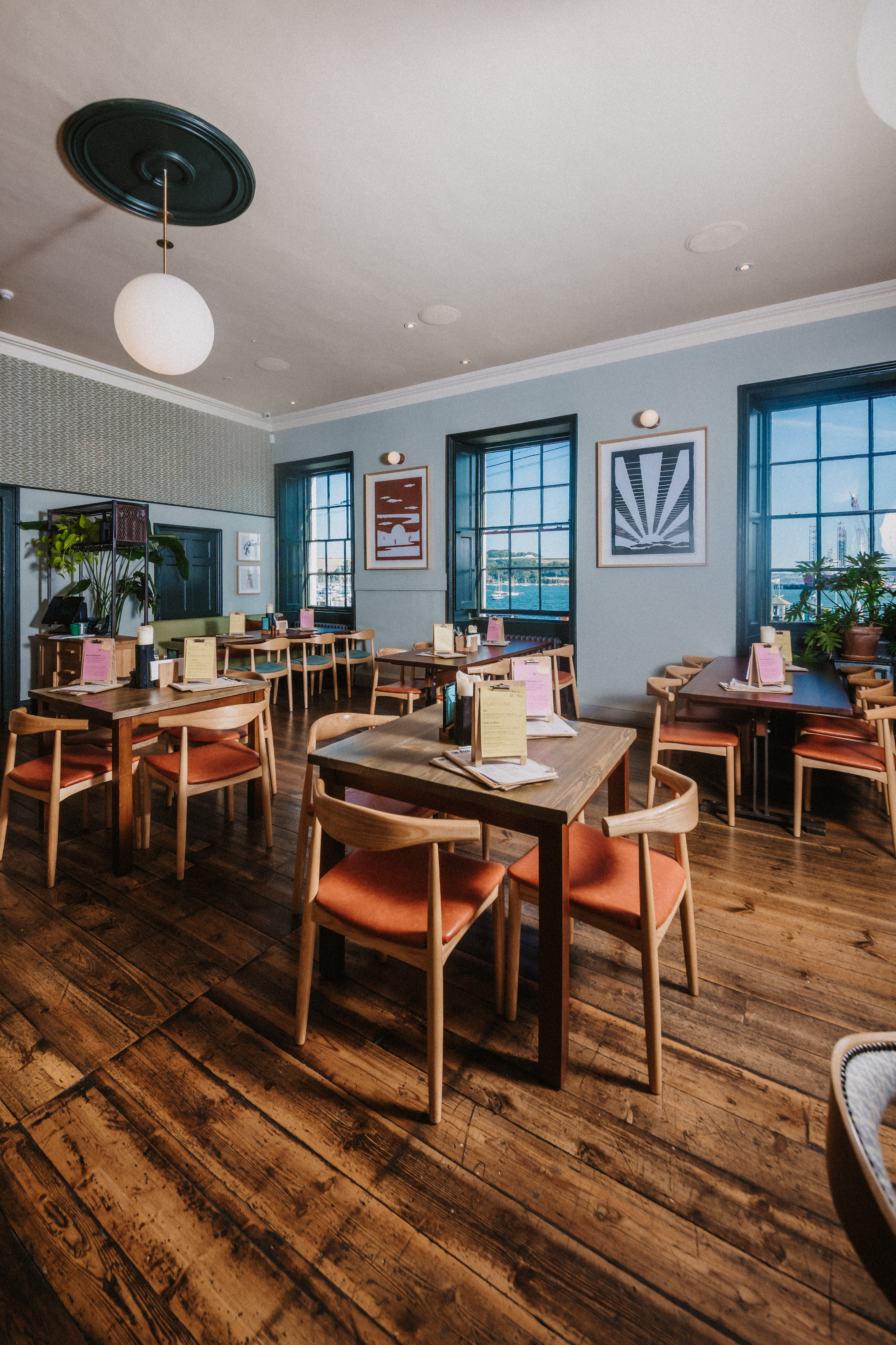Event space with wooden tables and natural light, ideal for networking and workshops.