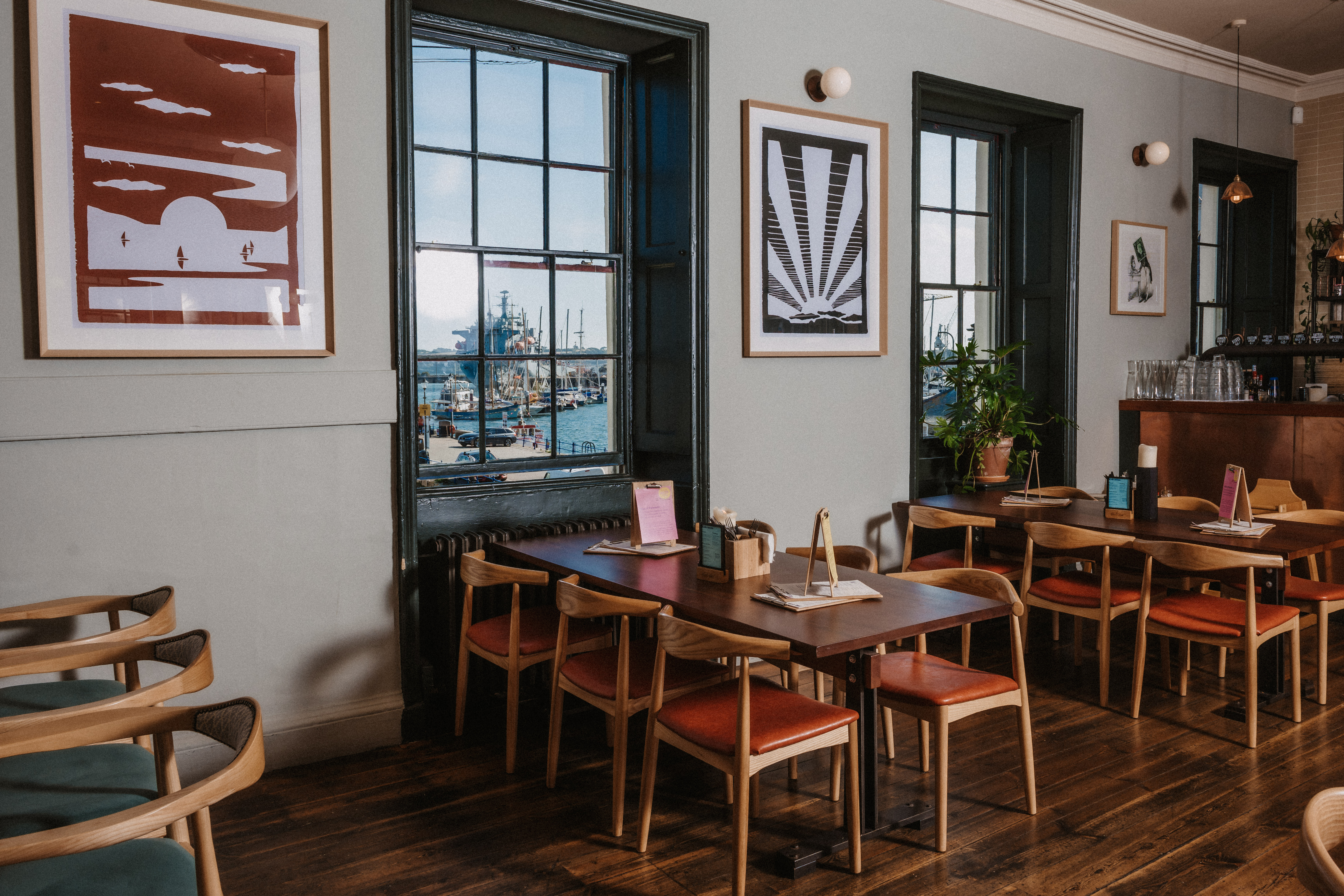 Stylish dining space with large windows for meetings and events at The Falmouth Stable.