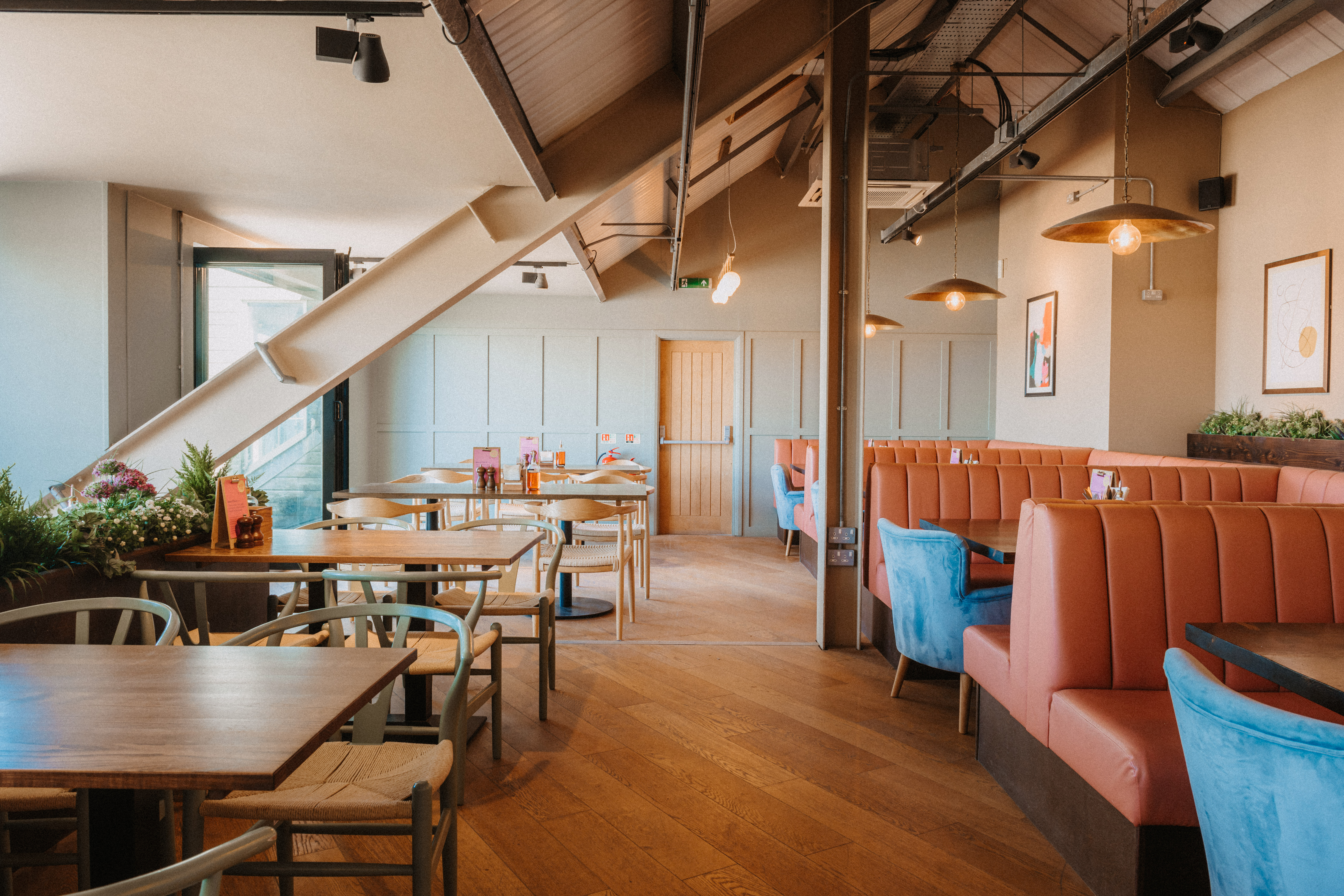 Modern restaurant venue with cozy booths for events and meetings at The Fistral Stable.