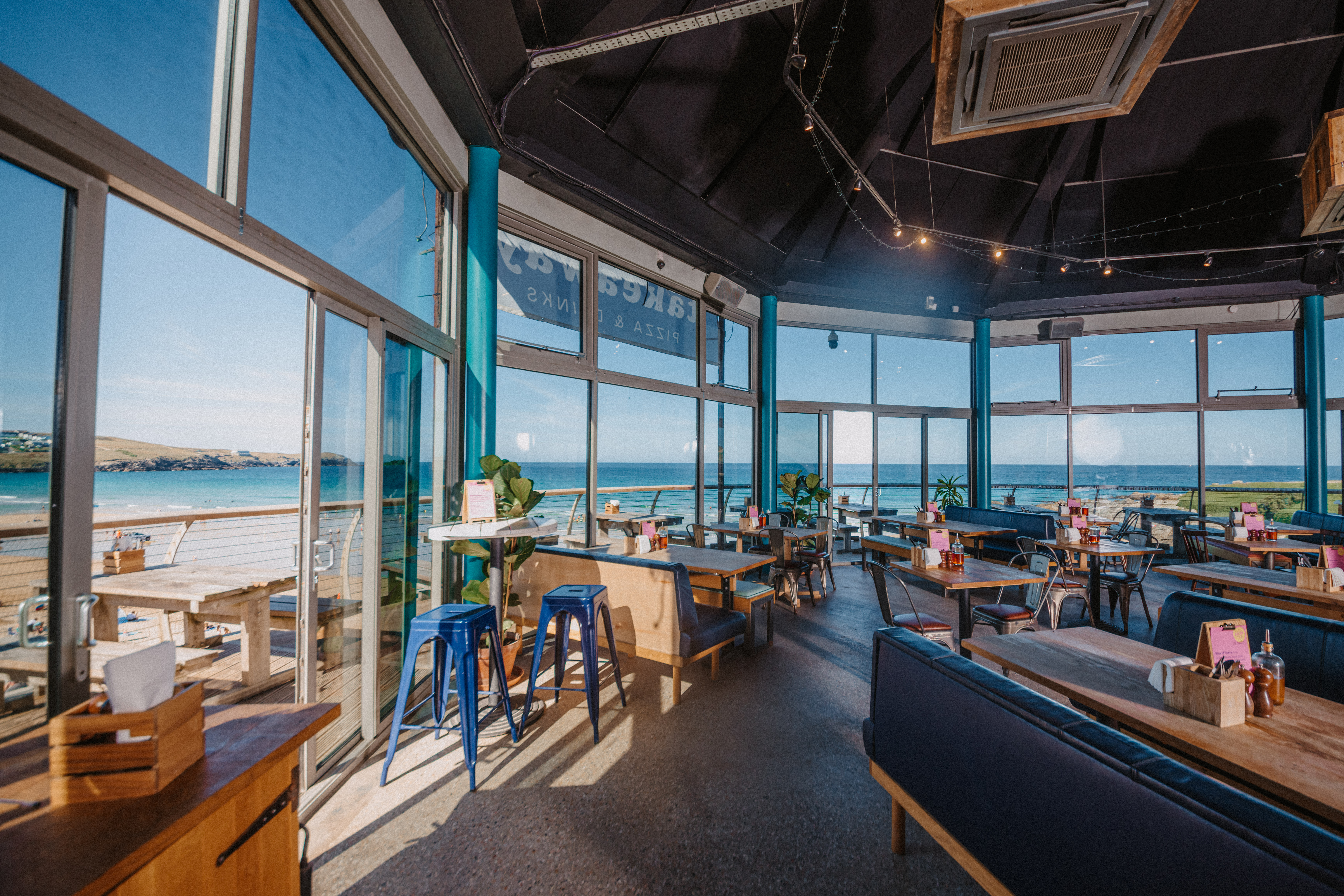 Bright event space with waterfront views, ideal for casual meetings and social gatherings.