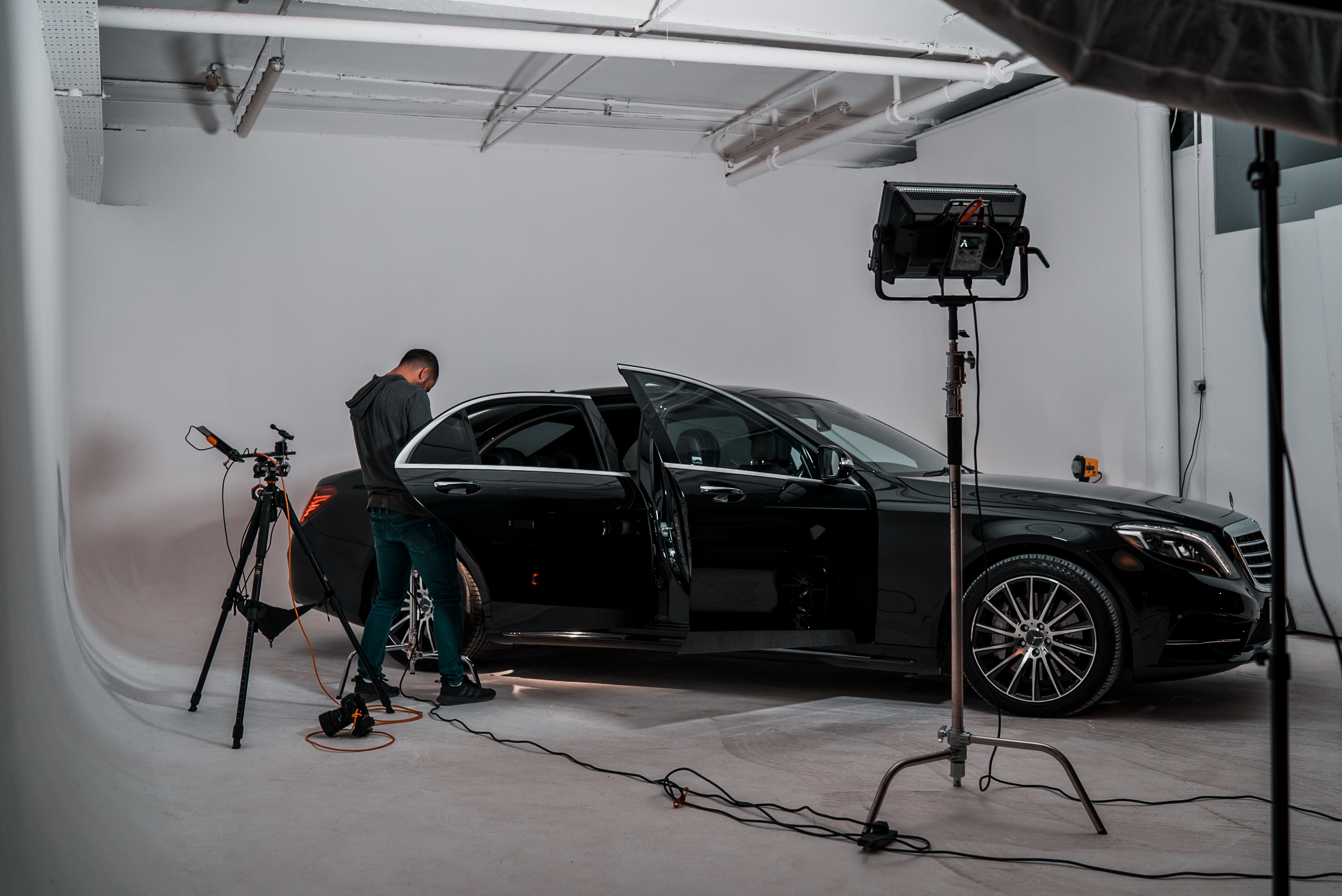 Sleek black car in studio for high-end automotive showcase and promotional events.