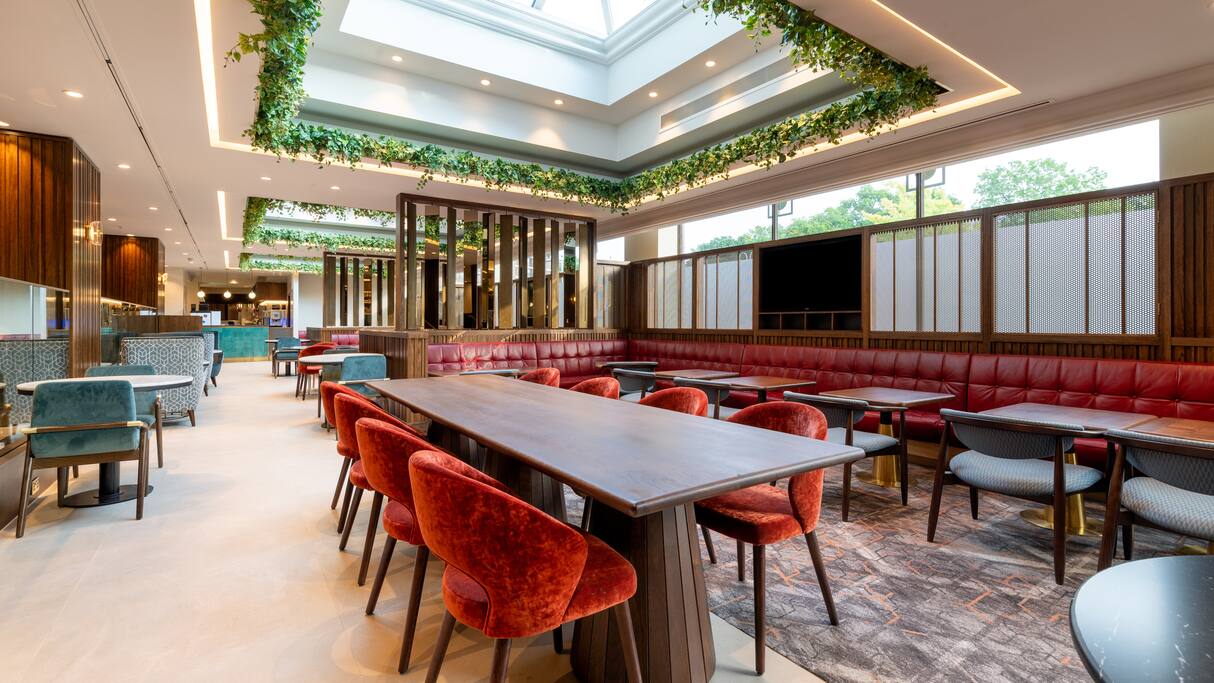 Modern event space at Hilton Birmingham Metropole with vibrant seating and natural light.