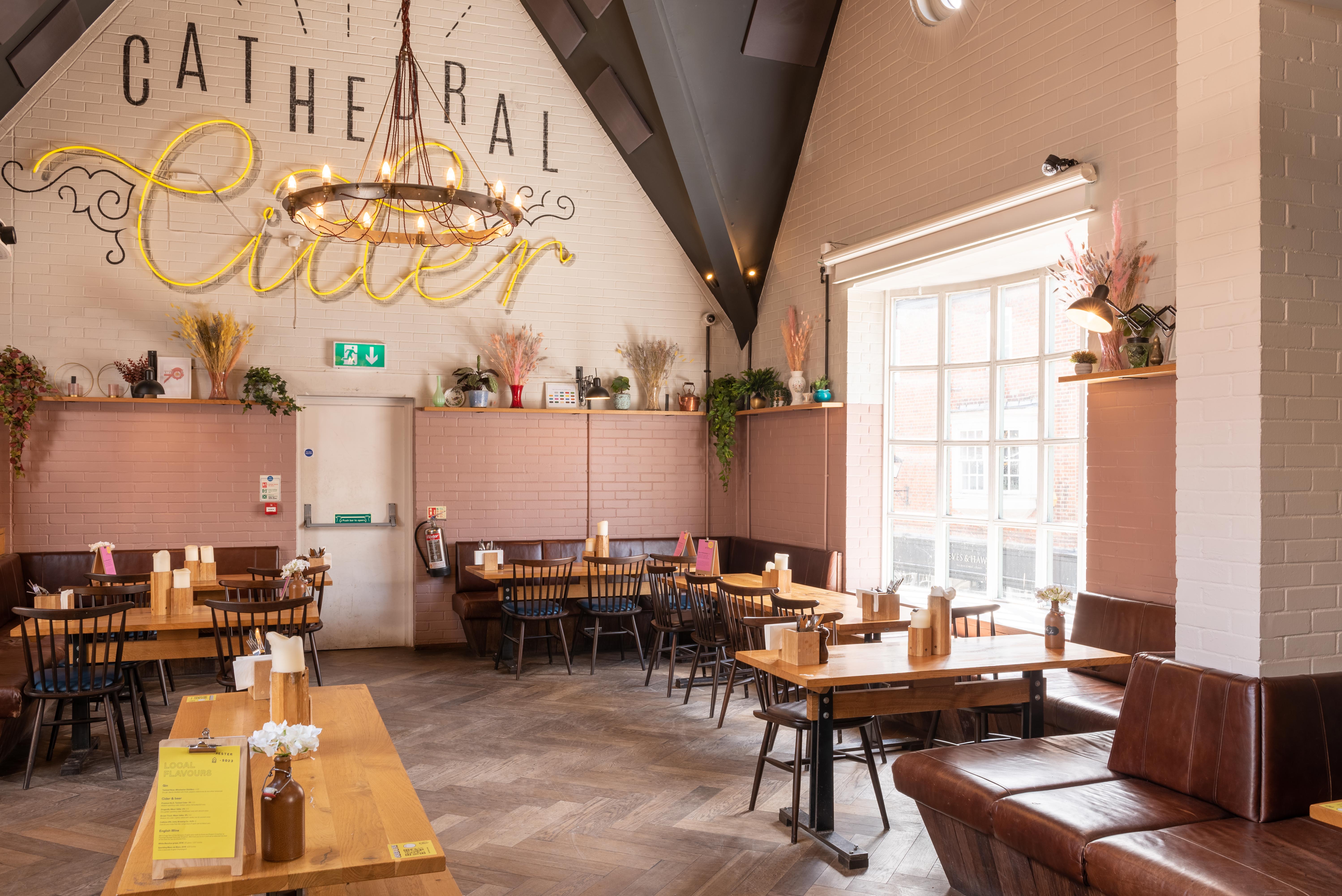 Stylish event space with wooden tables for casual gatherings and workshops at The Winchester Stable.