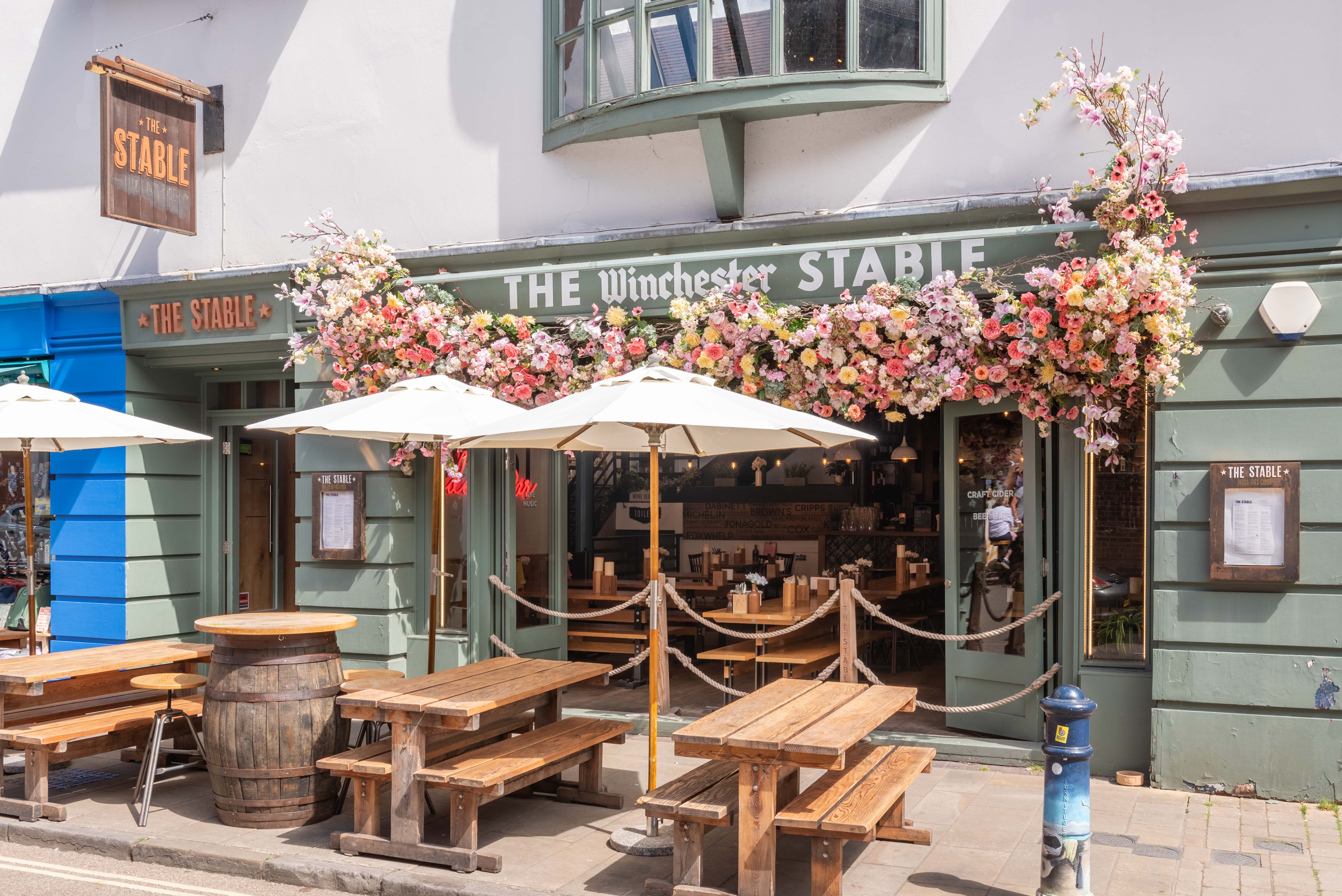 Charming outdoor venue with floral decor for casual meetings and social events.