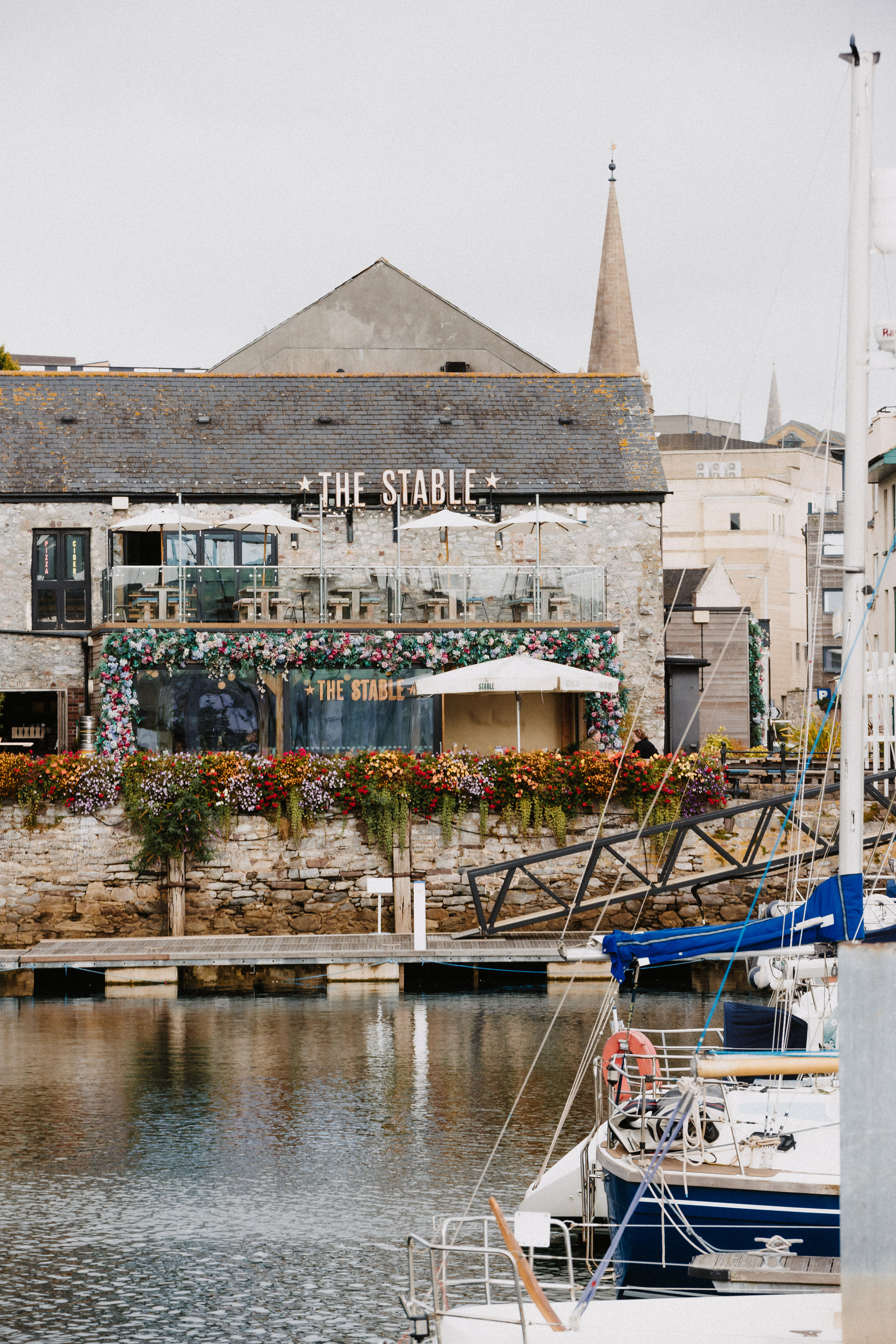 Charming waterfront venue hire with floral decor for events and gatherings.