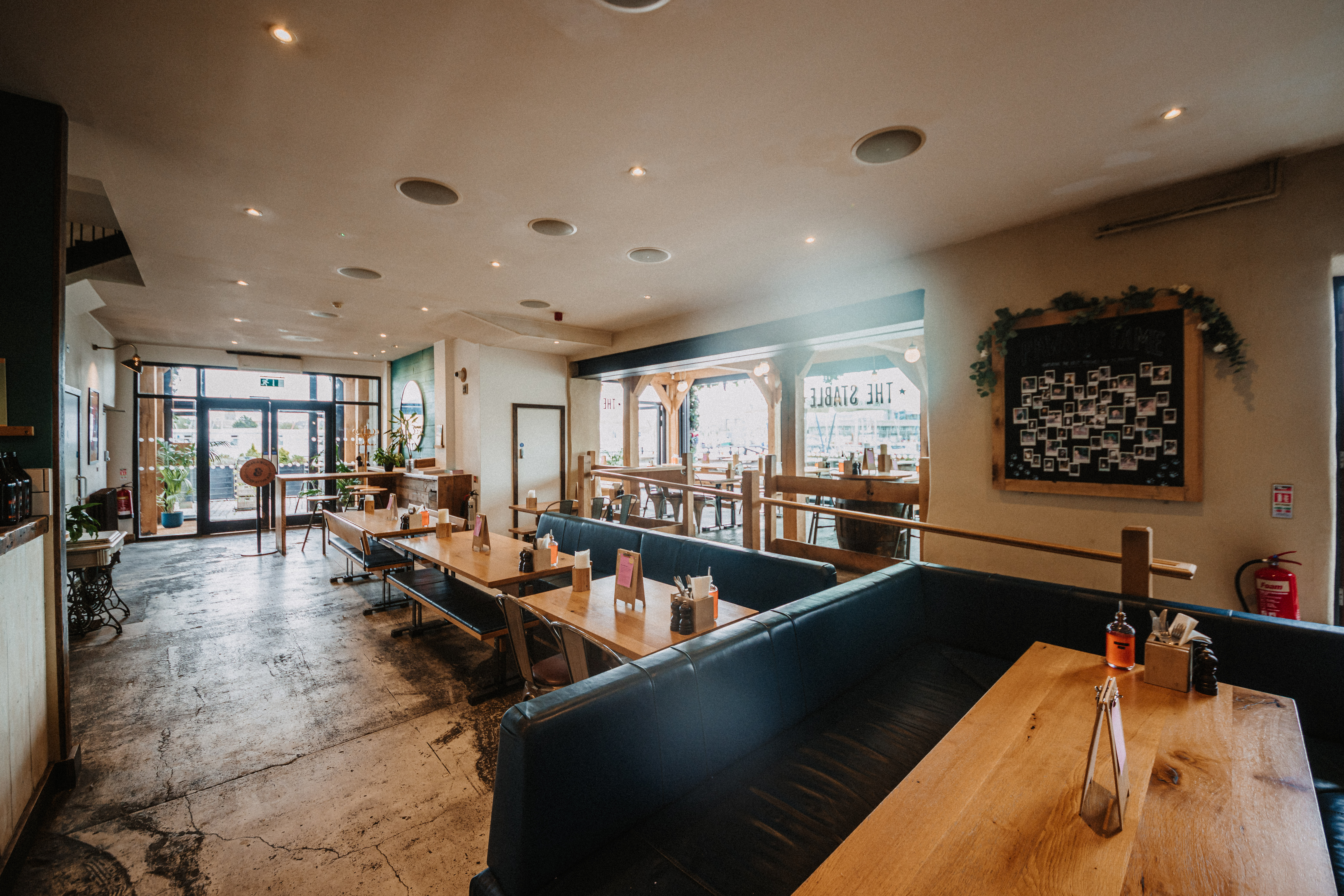 Spacious restaurant venue with communal tables for casual meetings and events in Plymouth.