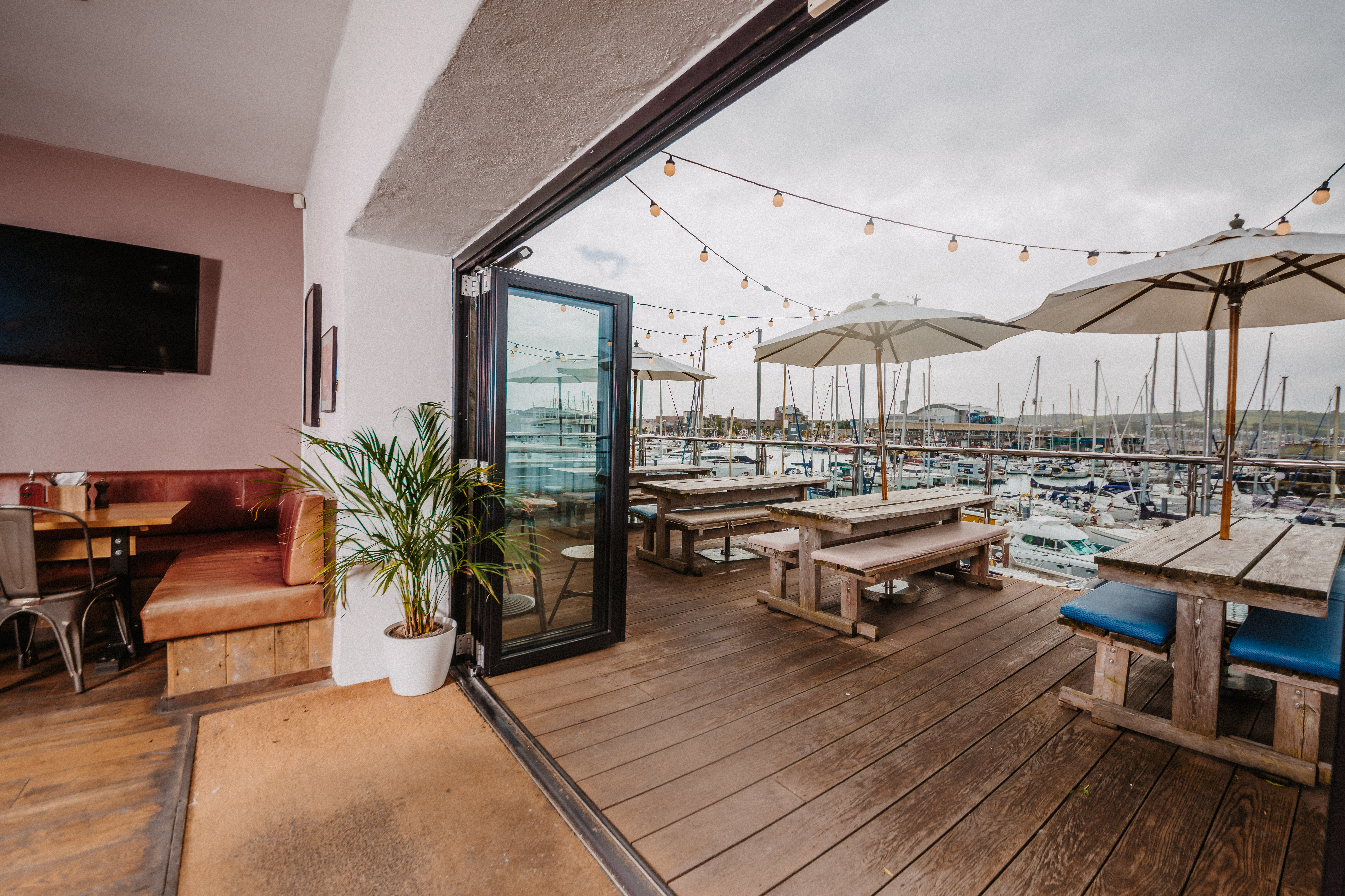 Top Deck outdoor event space with marina view, ideal for summer gatherings and networking.