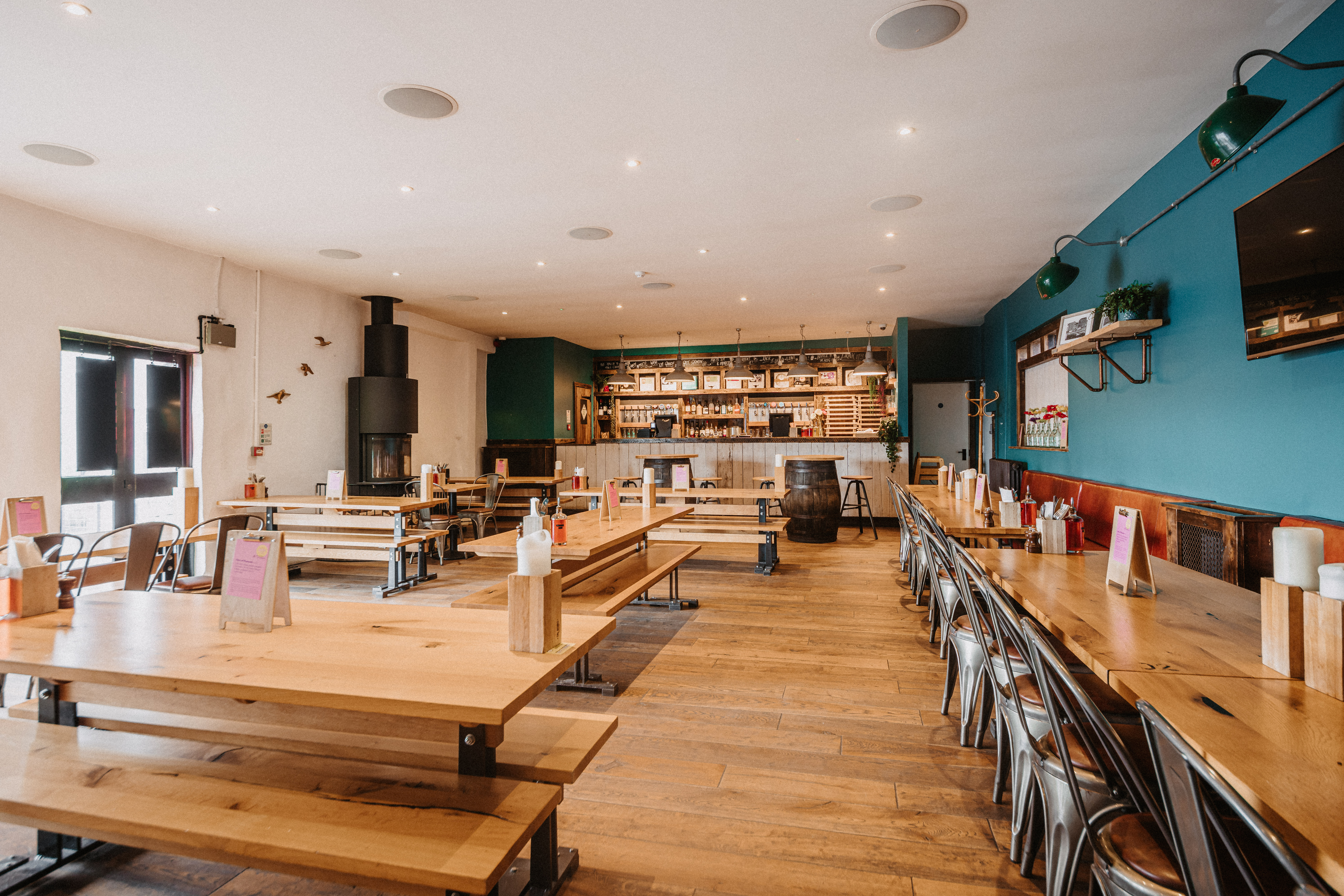 Top Deck event space with rustic wooden tables, ideal for networking and gatherings.