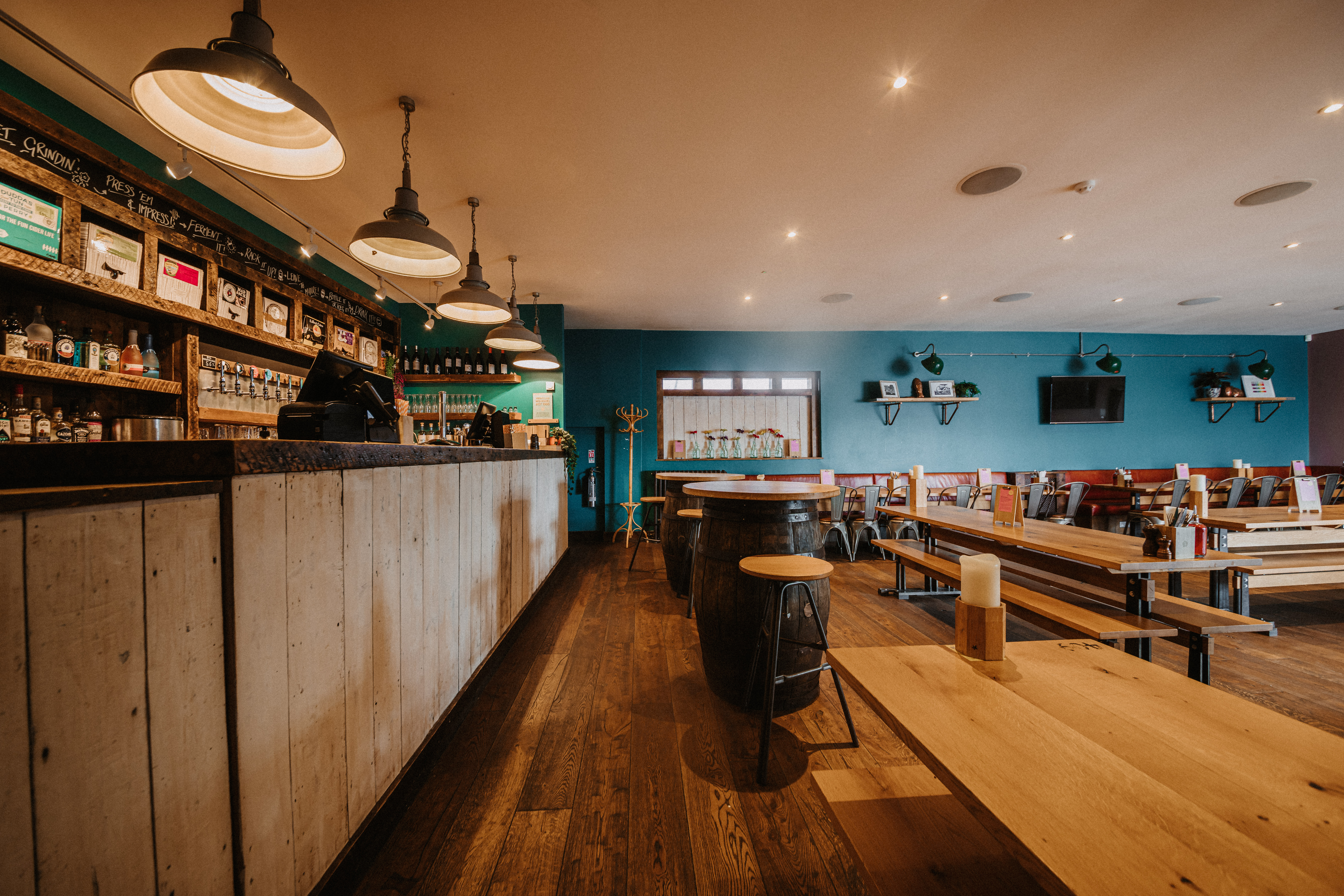 Top Deck event space with wooden tables, ideal for meetings and social gatherings.