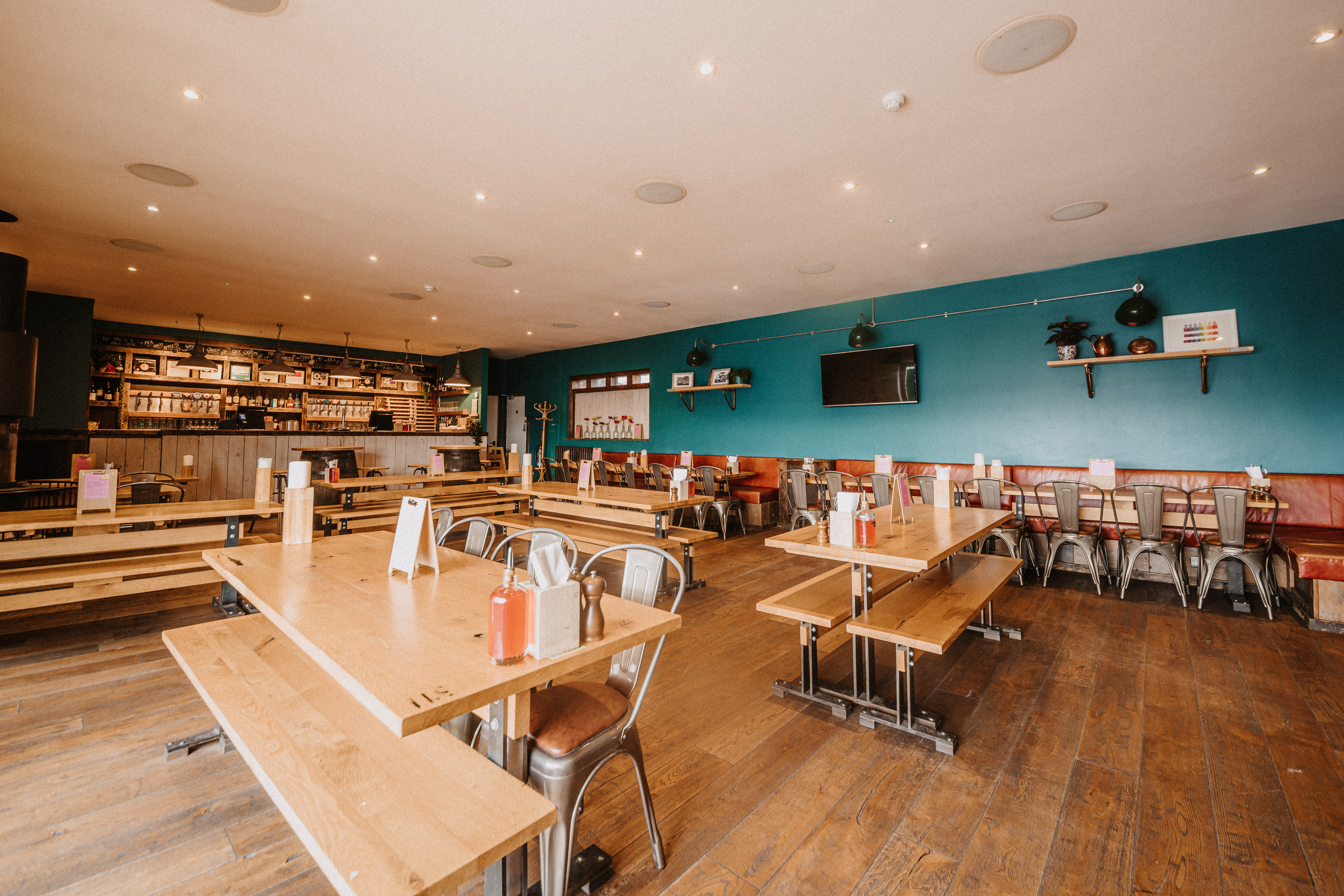 Spacious Top Deck venue with blue accent wall, ideal for networking events and gatherings.