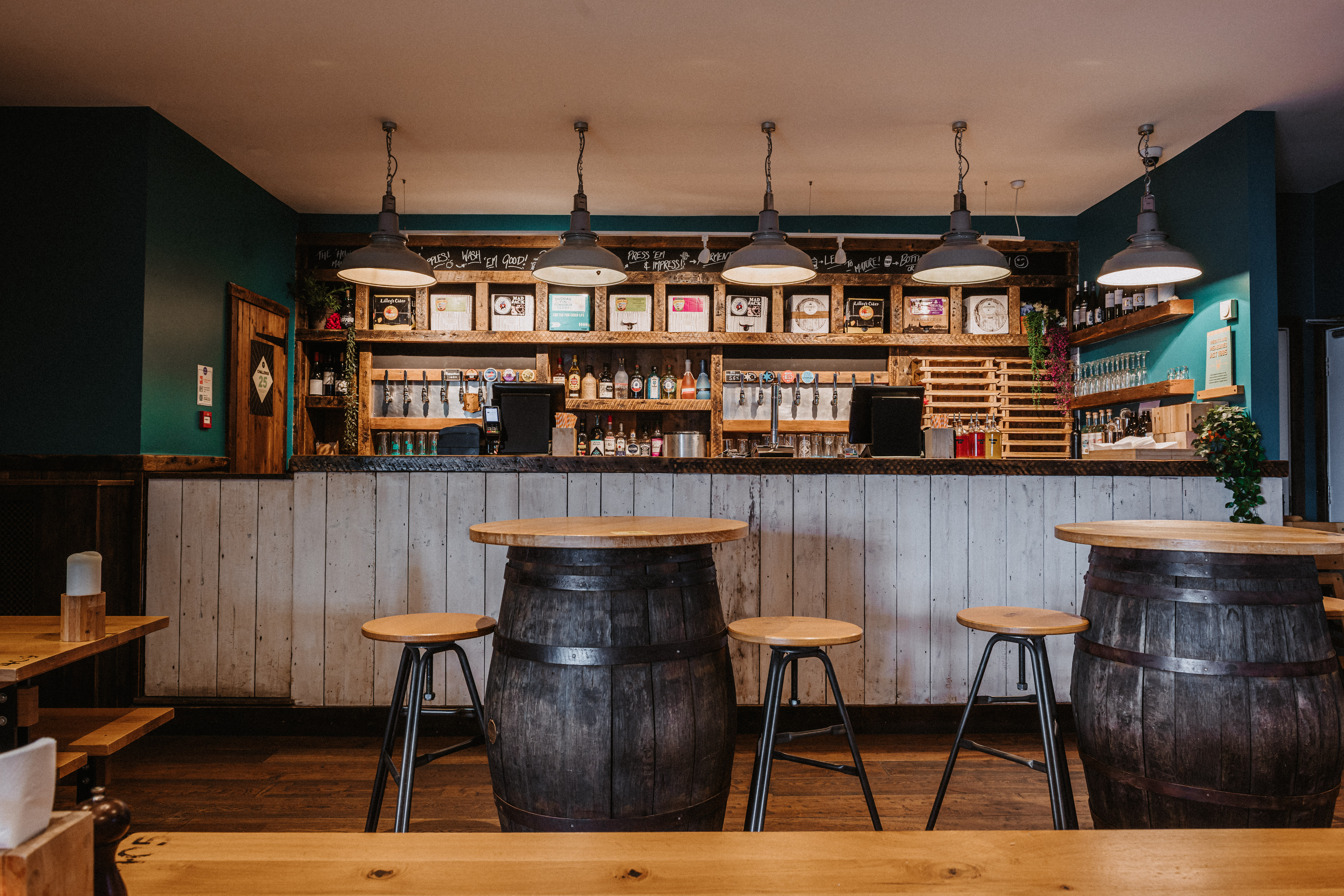 Cozy bar setup with wooden barrels, ideal for networking events in Plymouth Stable.