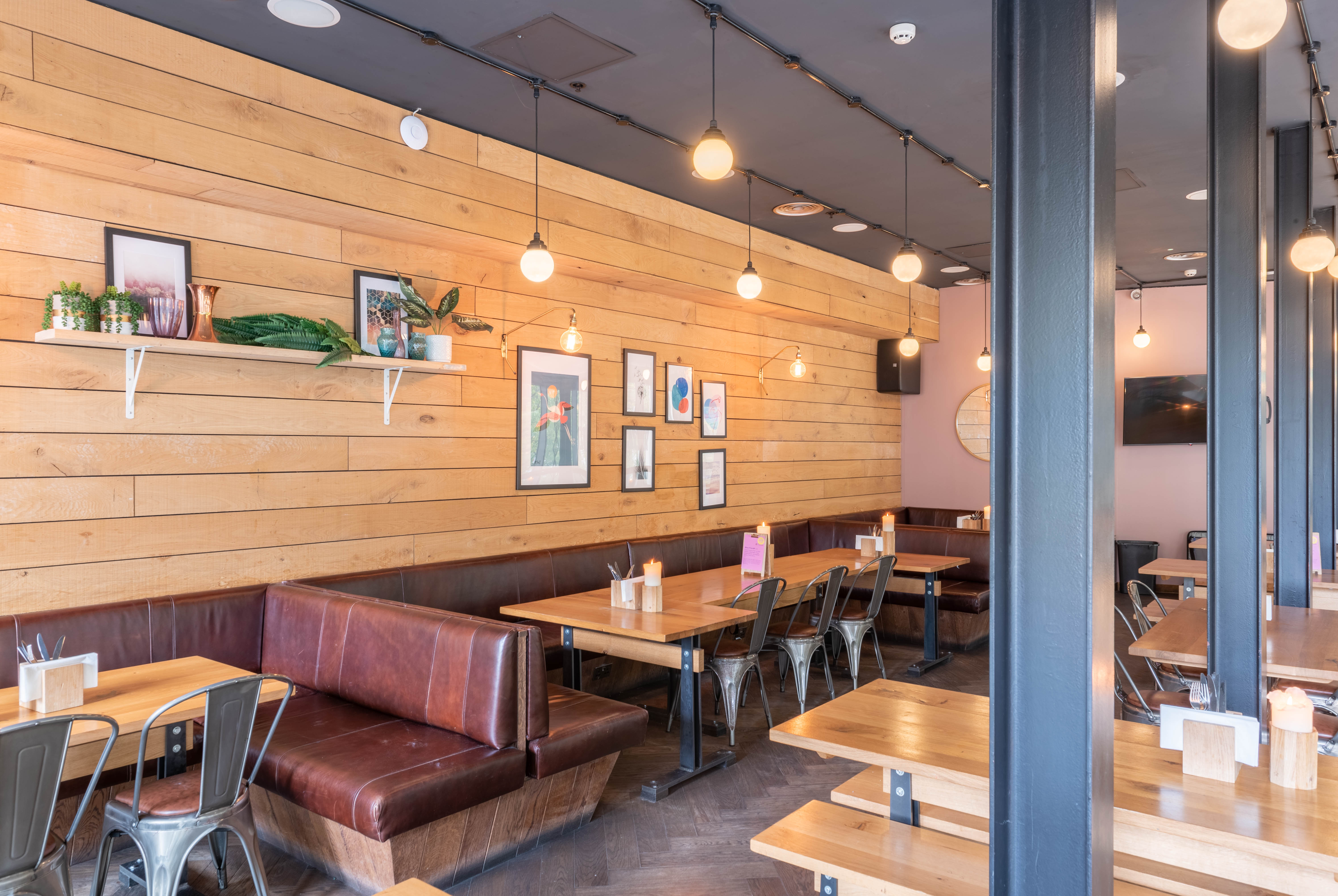 Modern restaurant interior with warm wood, ideal for casual meetings and events.