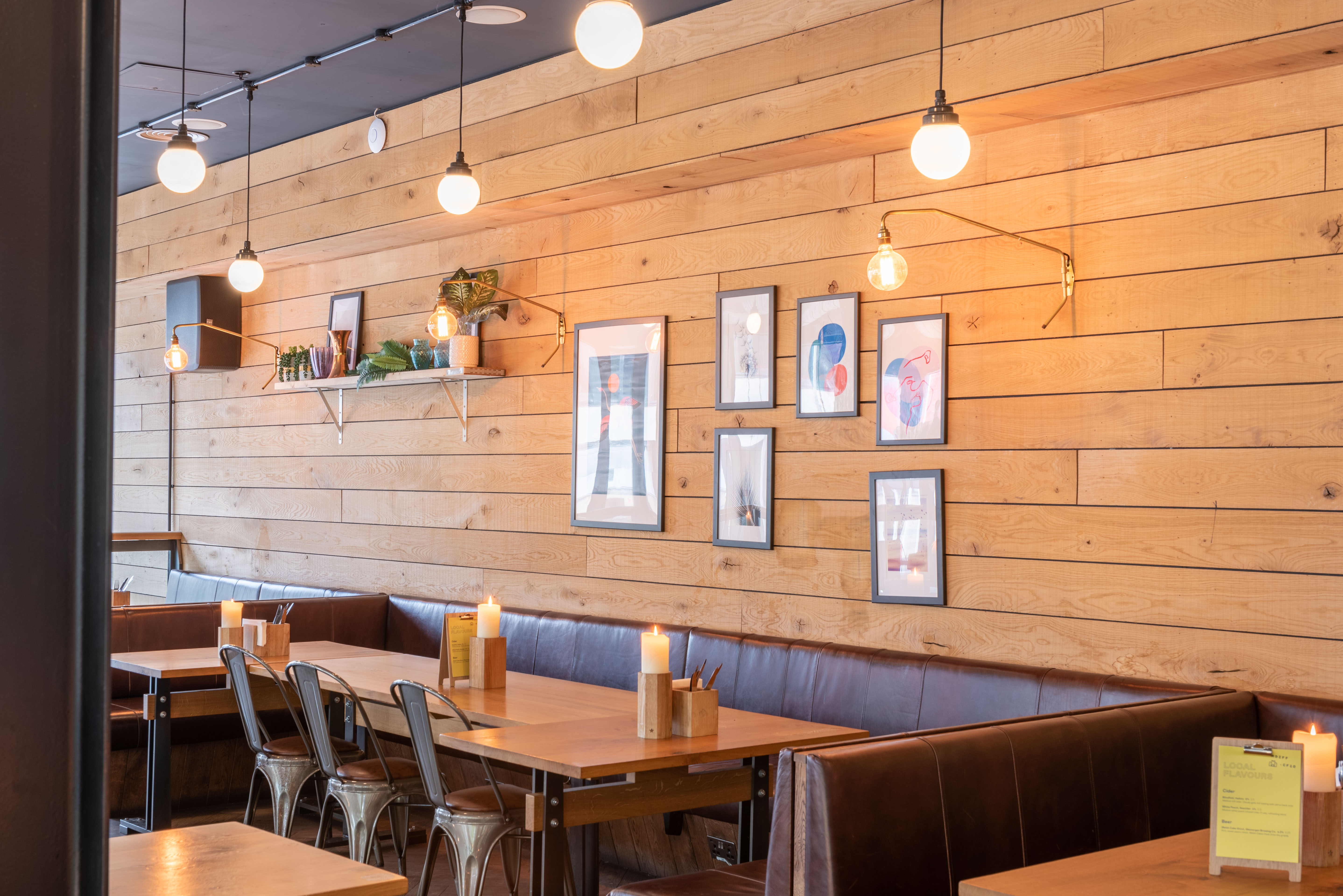 Cozy restaurant space with wooden walls, perfect for networking events and gatherings.