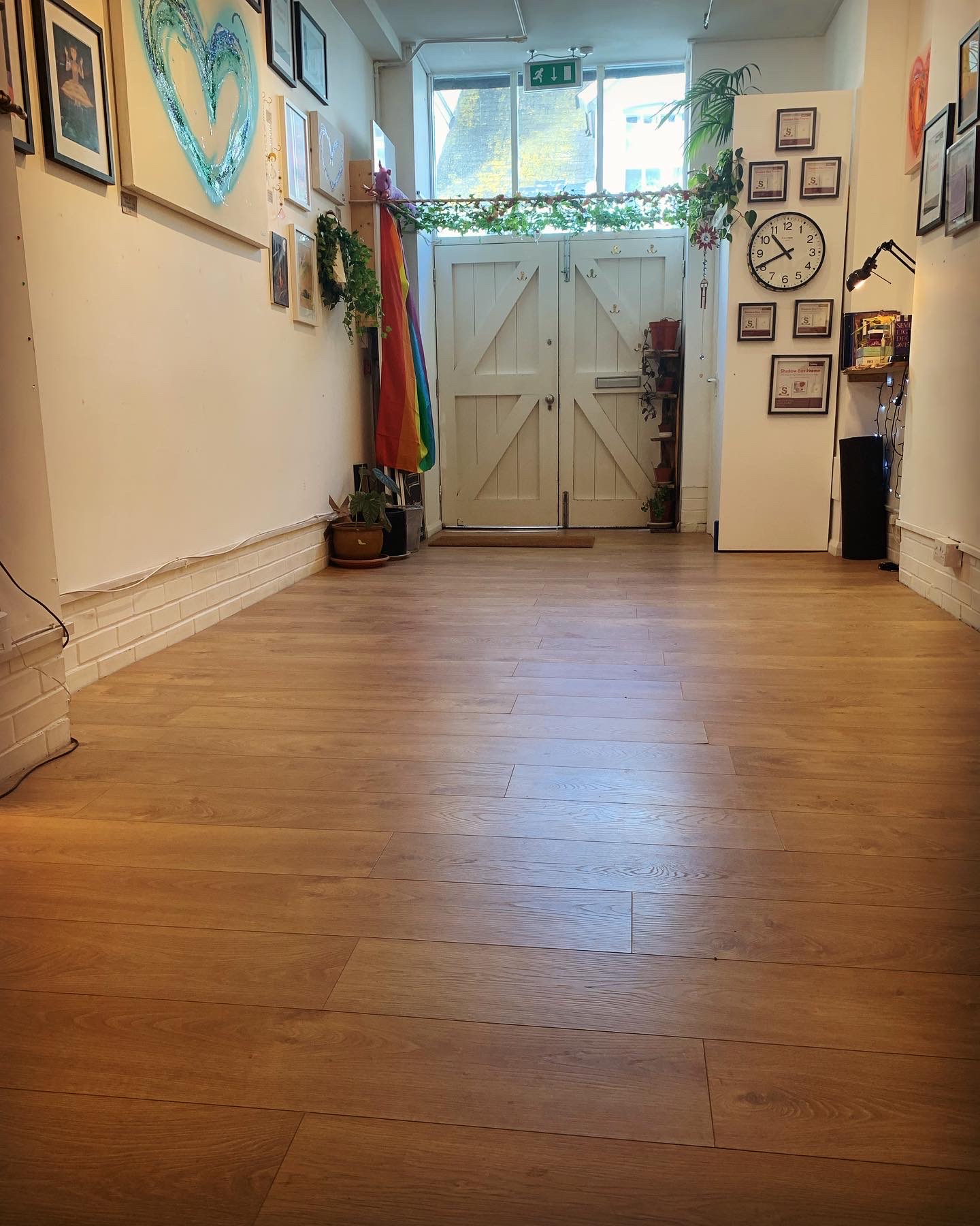 Spacious entryway of Sunflower Studio with wooden flooring, perfect for events and gatherings.