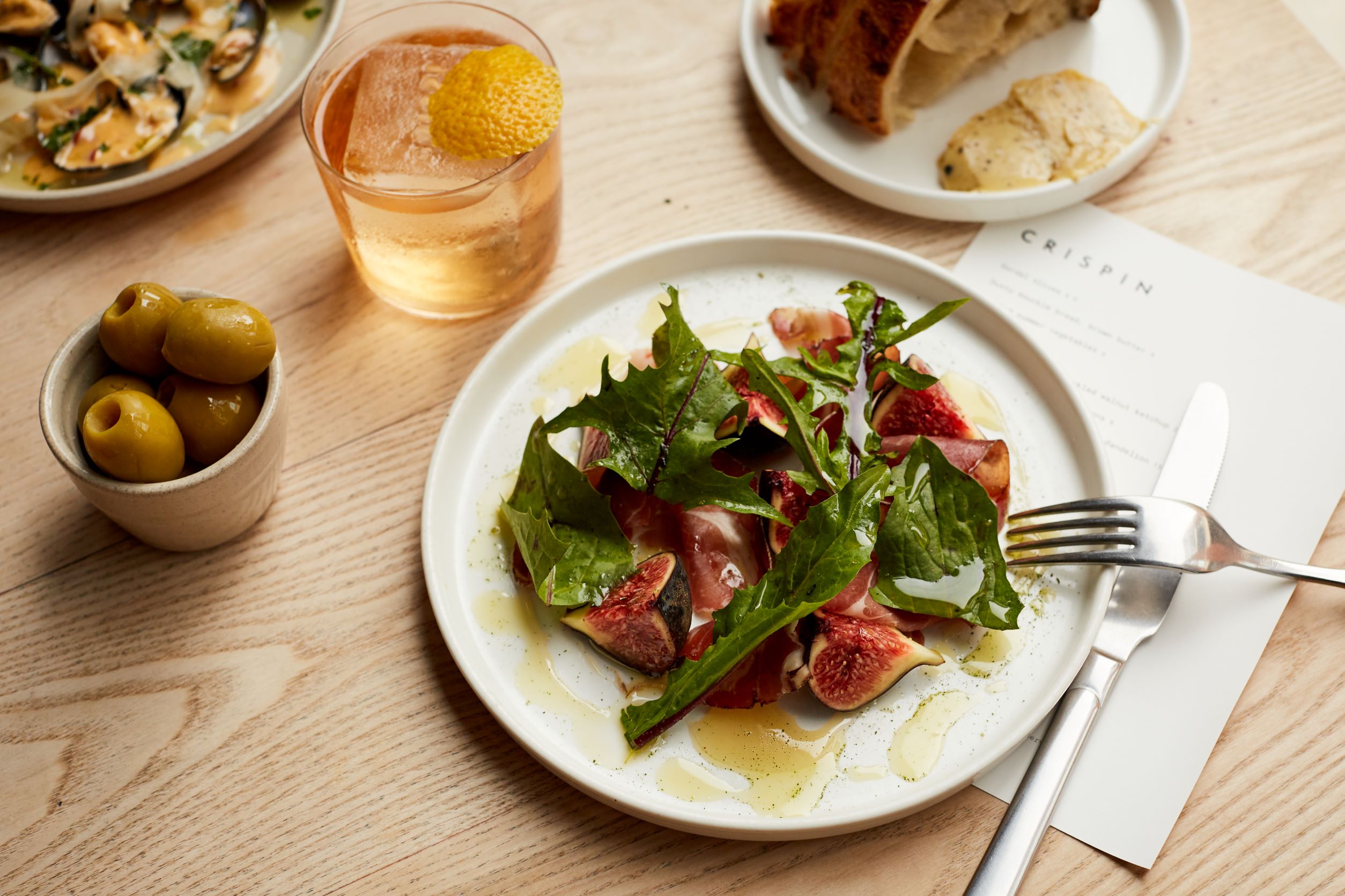 Upscale catering dish with fresh greens, figs, cocktail for events at Crispin Pavilion.