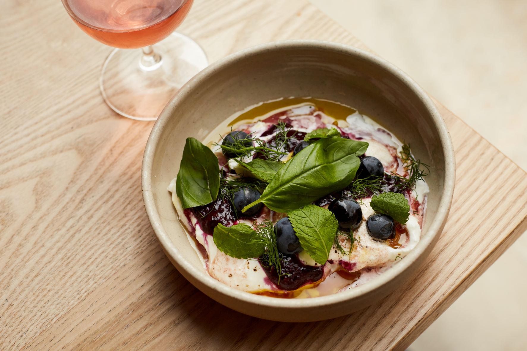 Crispin Pavilion dish with creamy textures, blueberries, and rosé for events and catering.