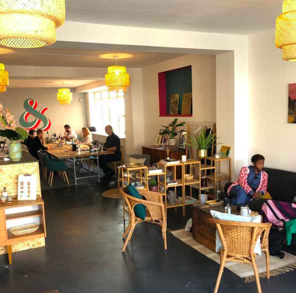 Cozy modern meeting space with communal tables for workshops and networking events.