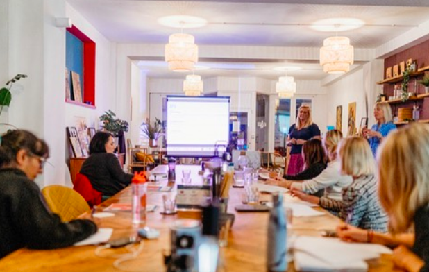 Modern meeting space with long table, bright lighting for productive events.