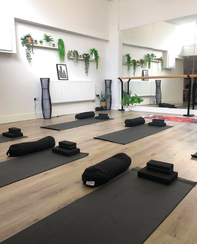 Serene yoga studio with mats, ideal for wellness retreats and mindfulness sessions.