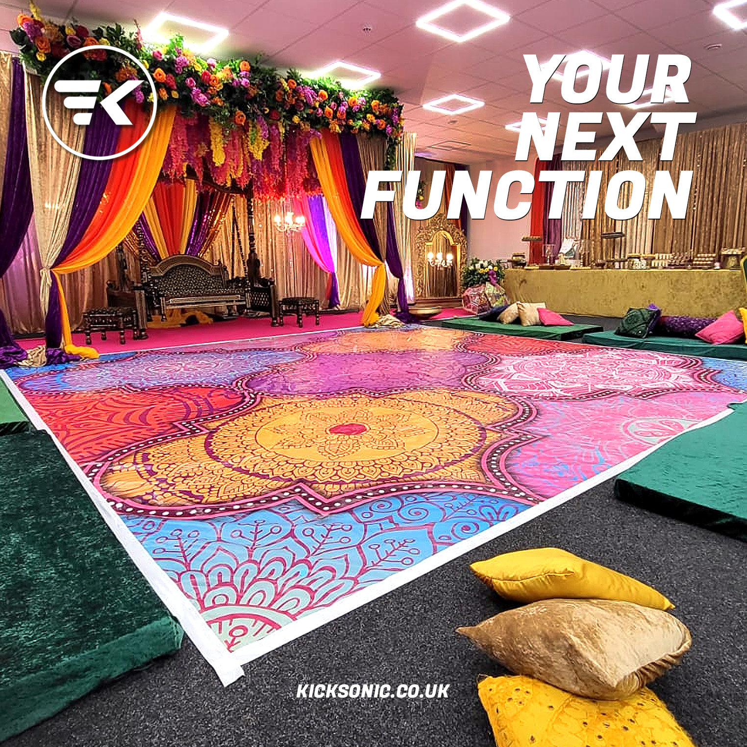 Vibrant event setup with intricate floor design for cultural celebrations or weddings.