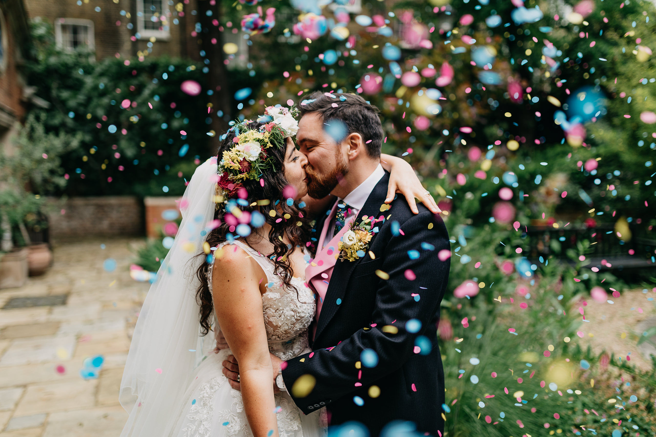Joyful wedding kiss with confetti at BMA House, perfect for memorable events.