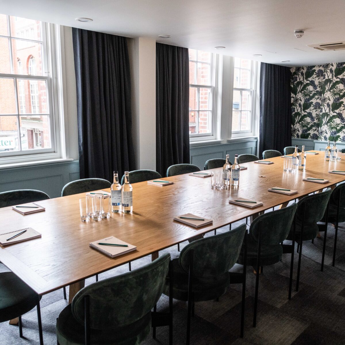 Meeting room in The Brigade with wooden table, ideal for workshops and collaboration.