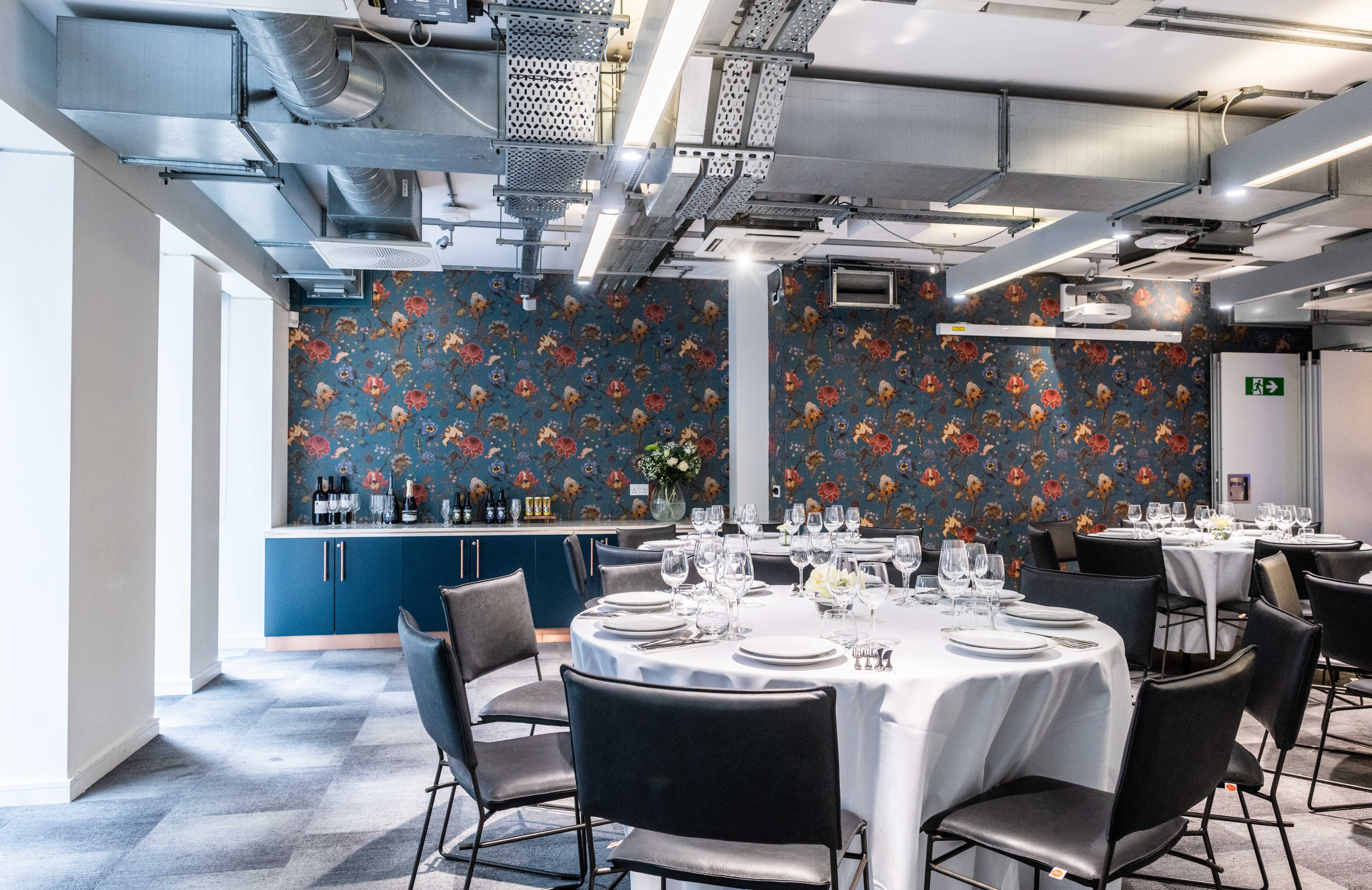 Elegant event space in Covent Garden with round tables for corporate gatherings.