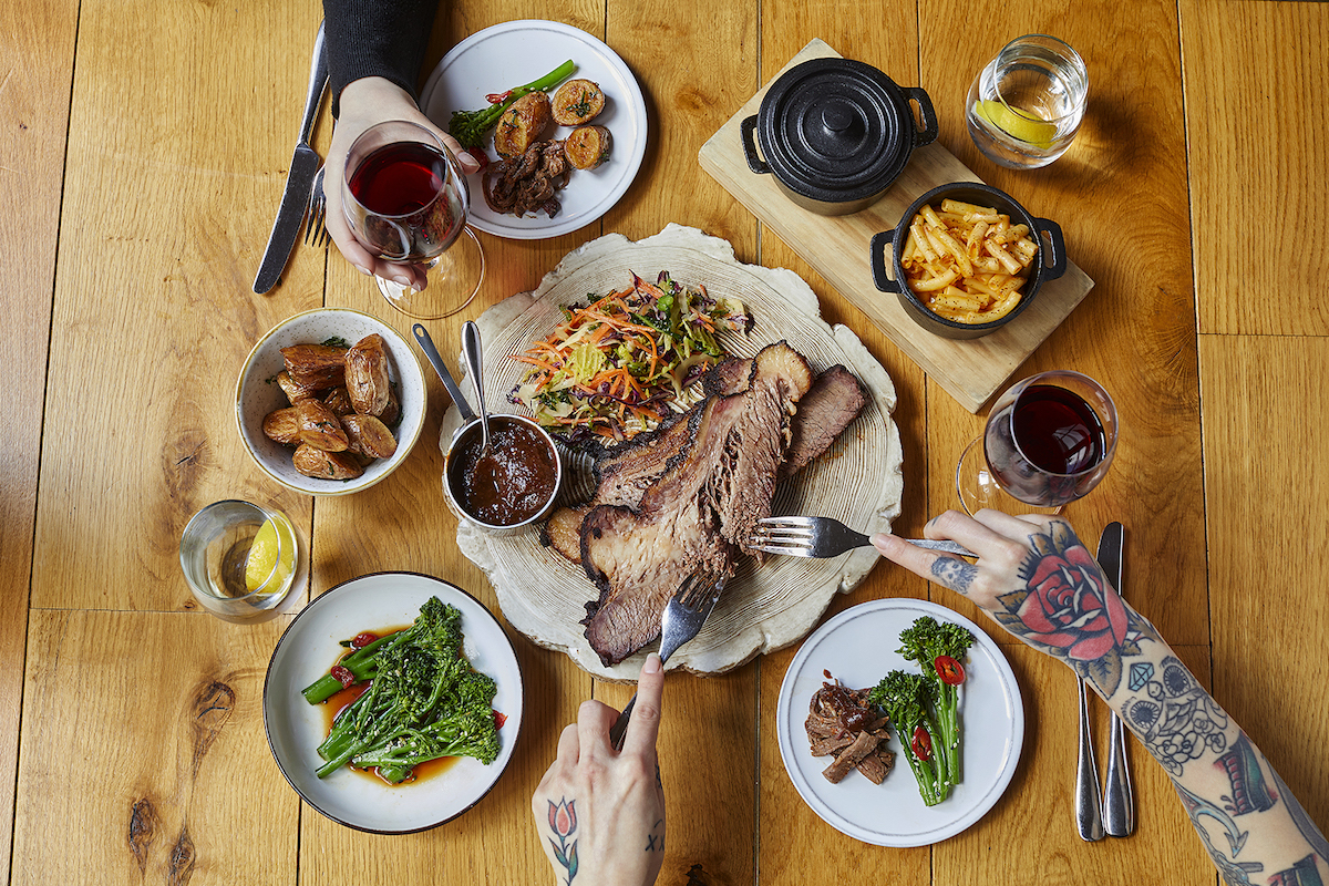 Dining table setup with brisket for corporate events and social gatherings.