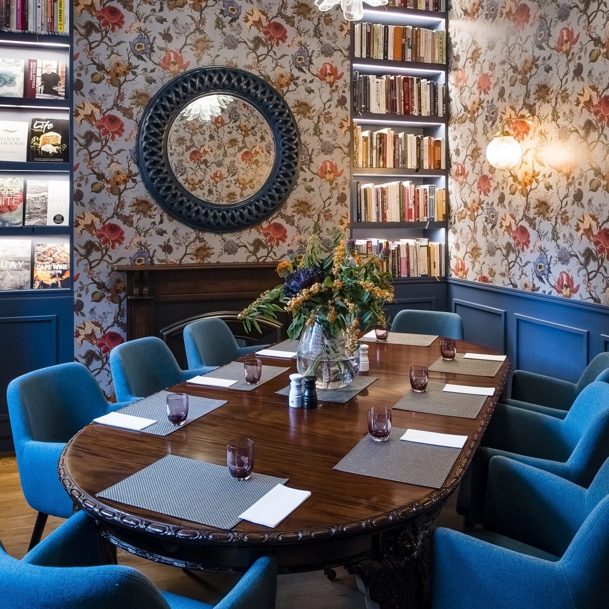 Elegant meeting room with floral wallpaper for intimate gatherings and brainstorming sessions.