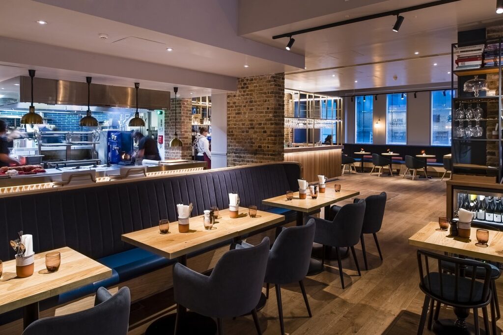 Modern restaurant with wooden tables, ideal for networking and private events.