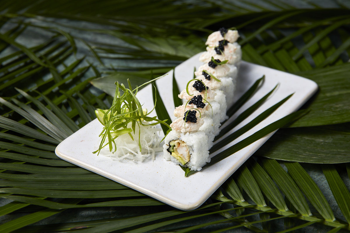 Elegant sushi dish on white plate, perfect for upscale events and gatherings.