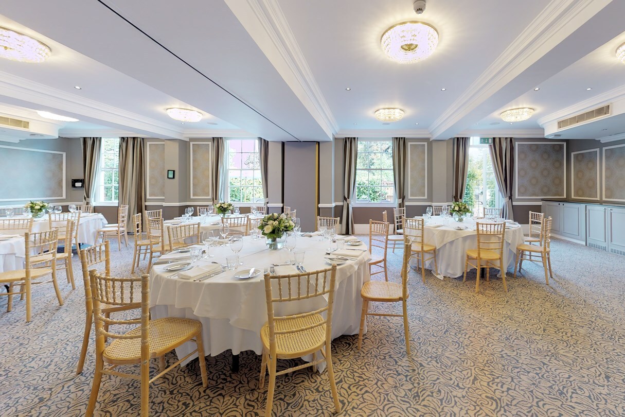 Elegant event space at Hotel du Vin Wimbledon with floral centerpieces for corporate meetings.