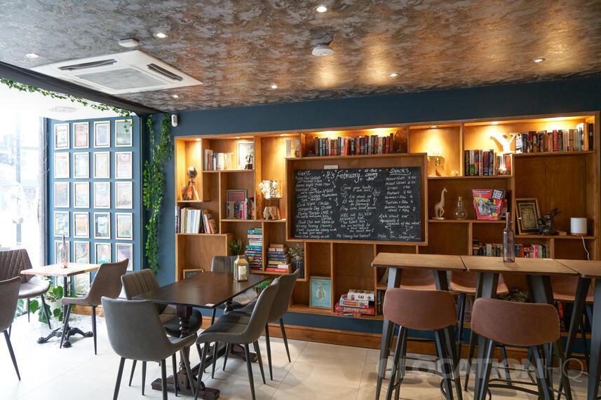 Cozy Literary Cocktail Coffee Bar with bookshelves, ideal for meetings and events.