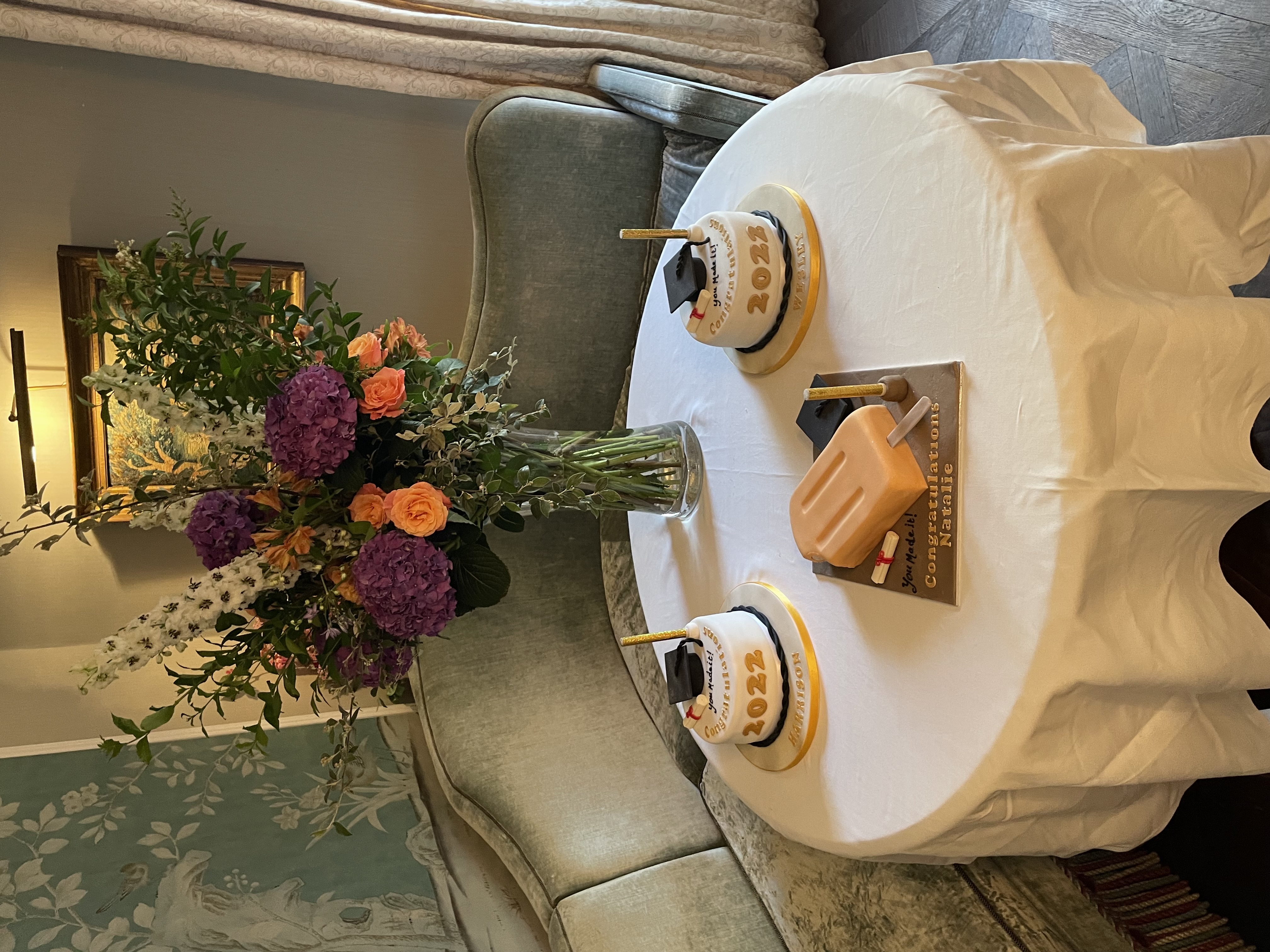 Elegant graduation cake display at No. Fifty Cheyne for a celebratory event.