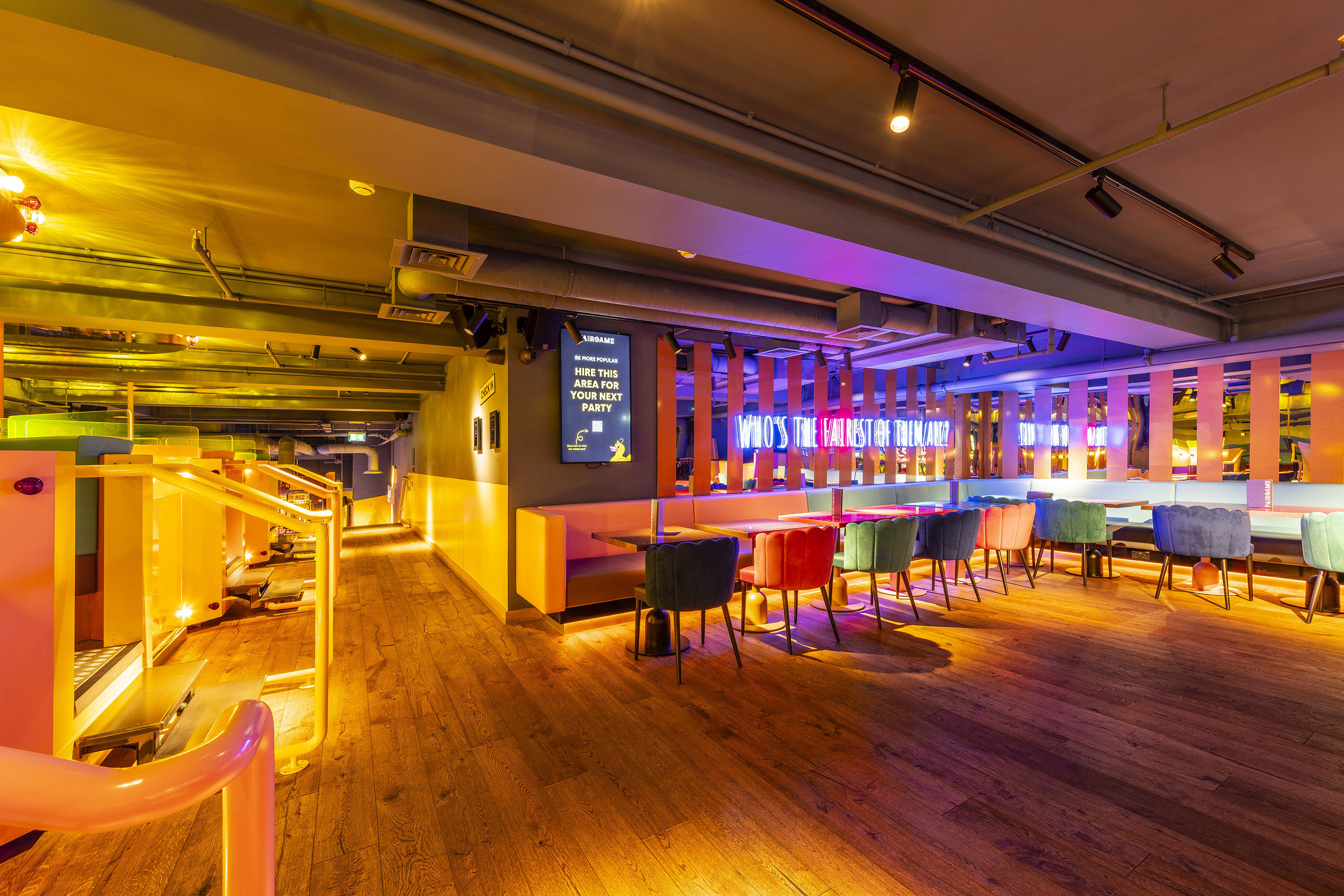 Golden Ticket event space with colorful lighting, perfect for meetings and gatherings.
