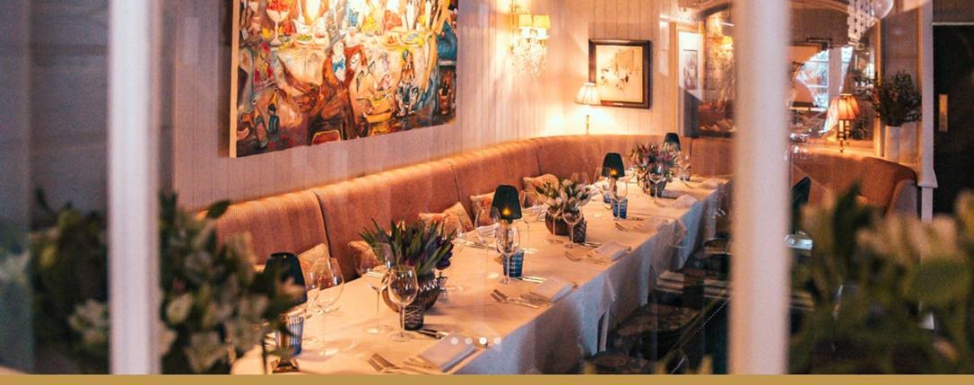 Elegant dining table with floral centerpieces at The Vineyard, ideal for corporate dinners.