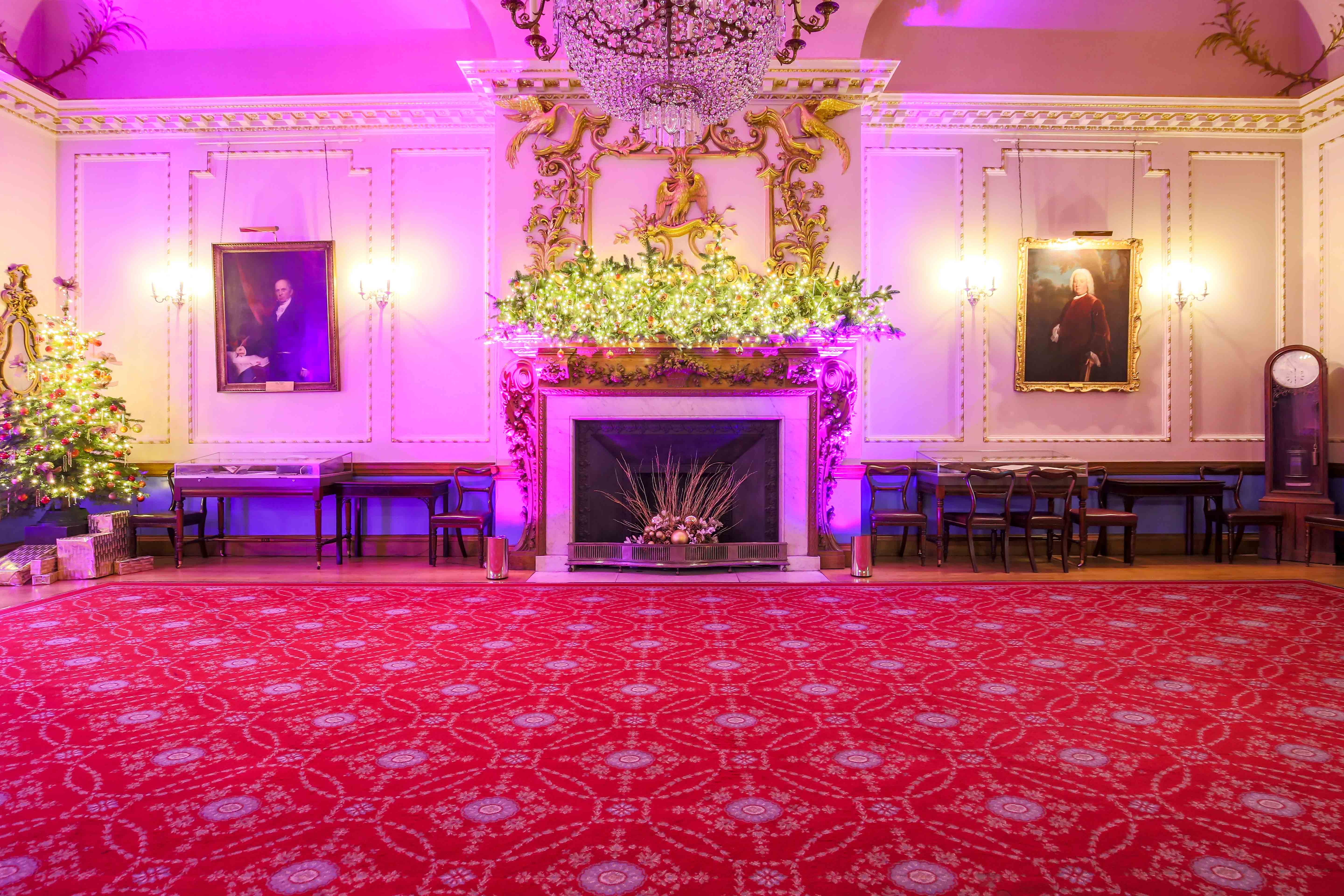 Christmas event at Stationers' Hall with elegant fireplace and floral decor.