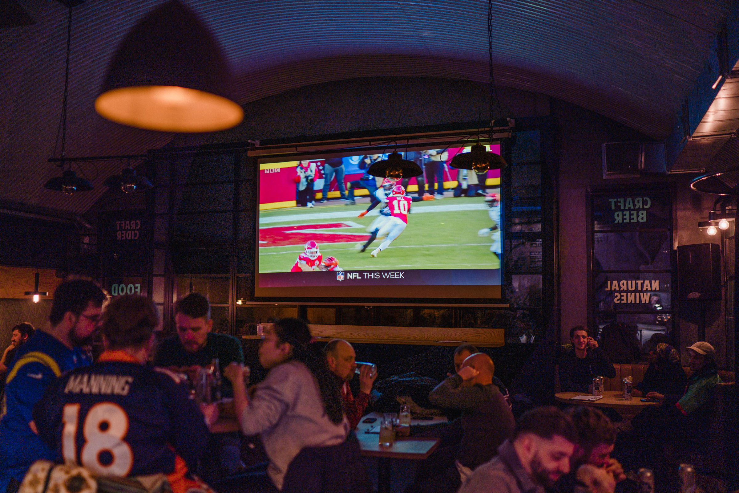 Lively Kilder bar with large screen, perfect for sports watch parties and networking events.