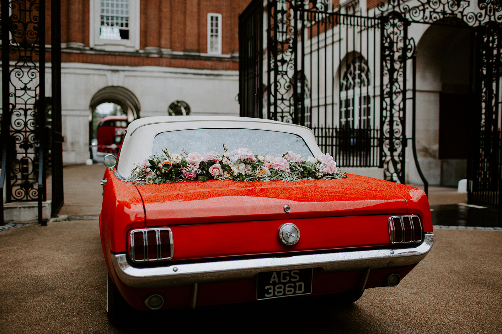 Classic red car with flowers at BMA House, ideal for weddings and upscale events.