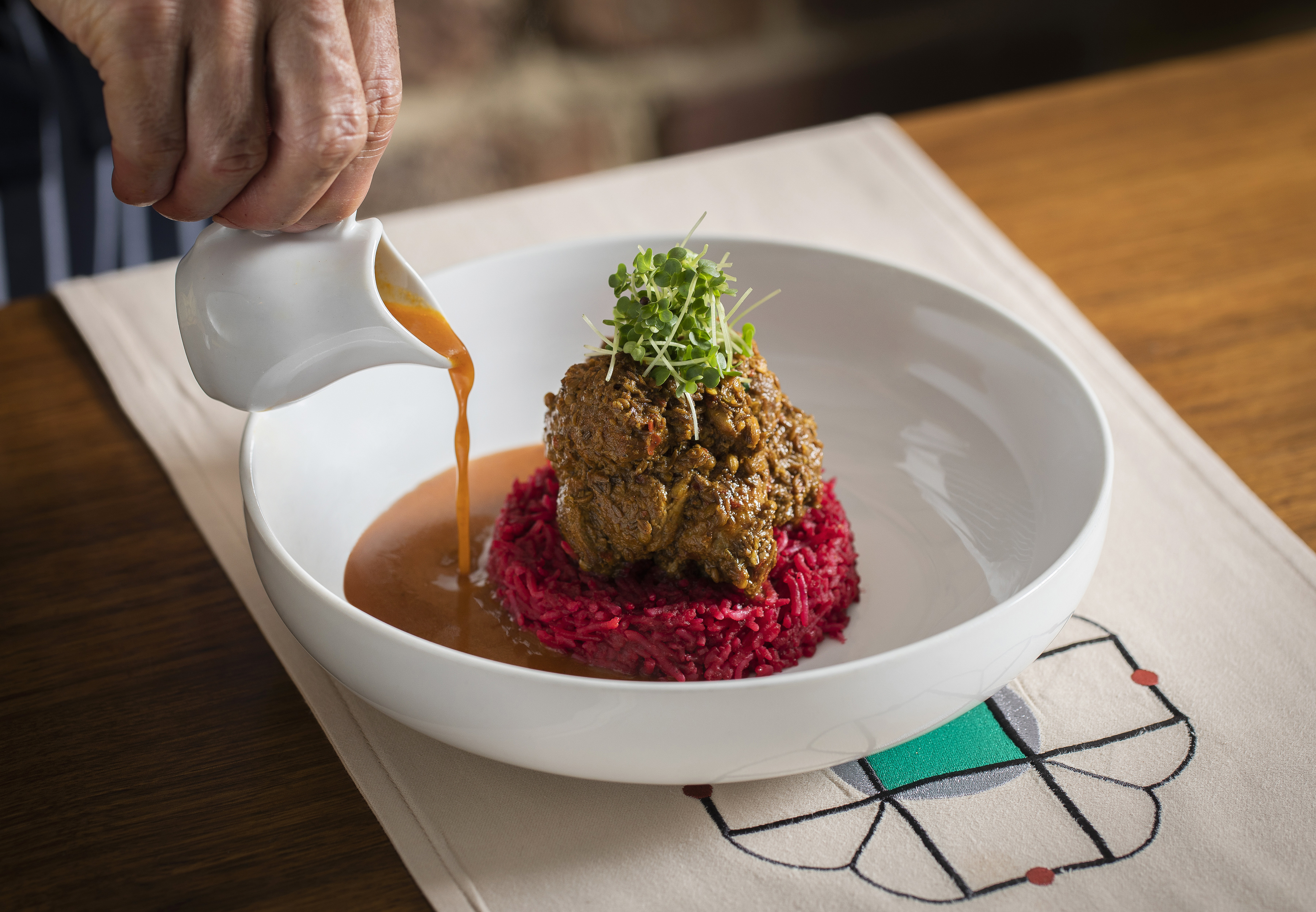 "Upscale dish with protein on beetroot risotto, ideal for corporate events and weddings."